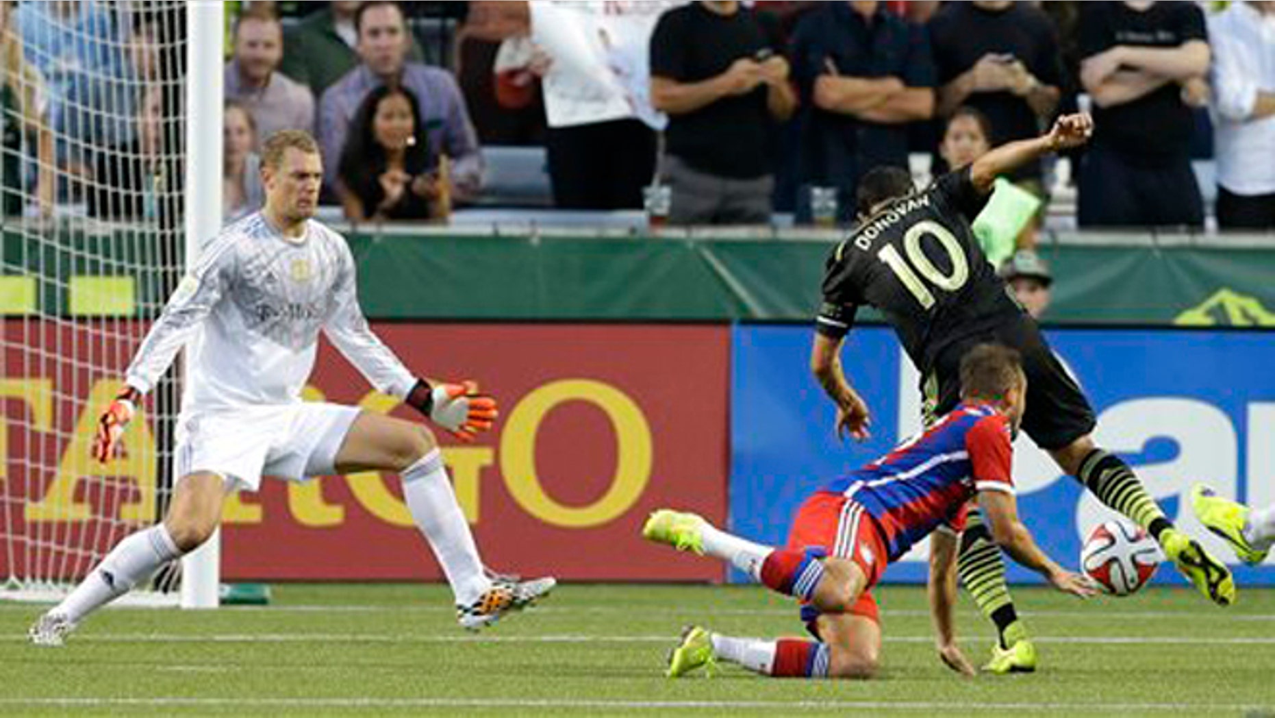 Los Angeles Galaxy forward Landon Donovan (10) scores the go-ahead goal on Bayern Munich goalkeeper Manuel Neuer, left, and around the defense of Rafinha, second from left, in the second half of the MLS All-Star soccer game, Wednesday, Aug. 6, 2014, in Portland, Ore. The MLS All-Stars won 2-1. (AP Photo/Ted S. Warren)