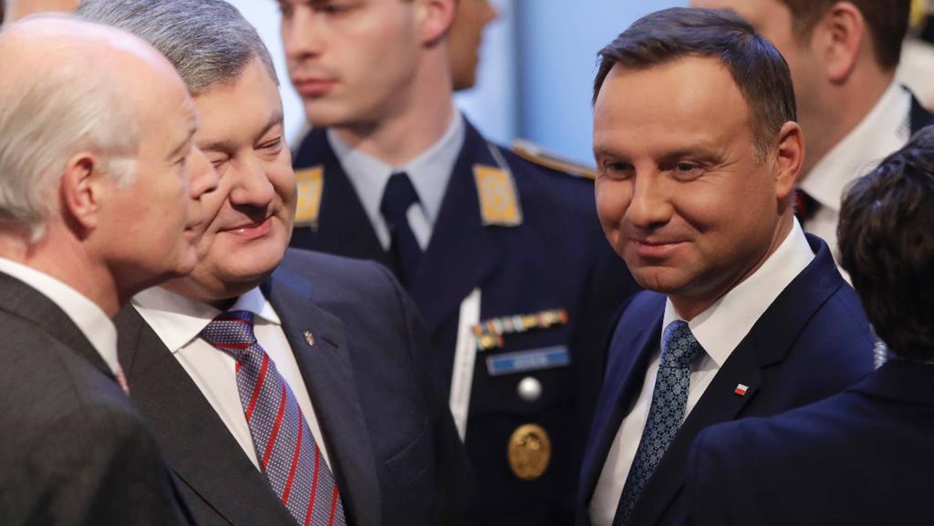 Polish President Andrzej Duda,right, and the president of Ukraine Petro Poroshenko chat during the Munich Security Conference in Munich, southern Germany, Friday, Feb. 17, 2017. The annual weekend gathering is known for providing an open and informal platform to meet in close quarters. (AP Photo/Matthias Schrader)