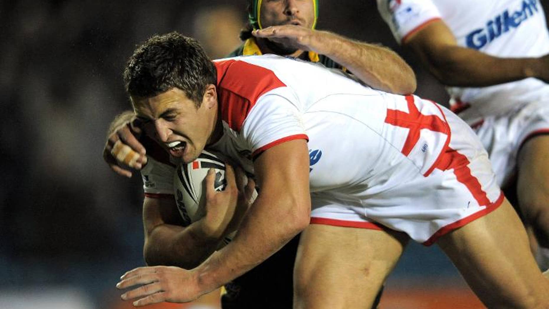 England's Sam Burgess (left) evades a tackle from Australia's Johnathan Thurston during a rugby league international at Elland Road, northern England, on November 14, 2009