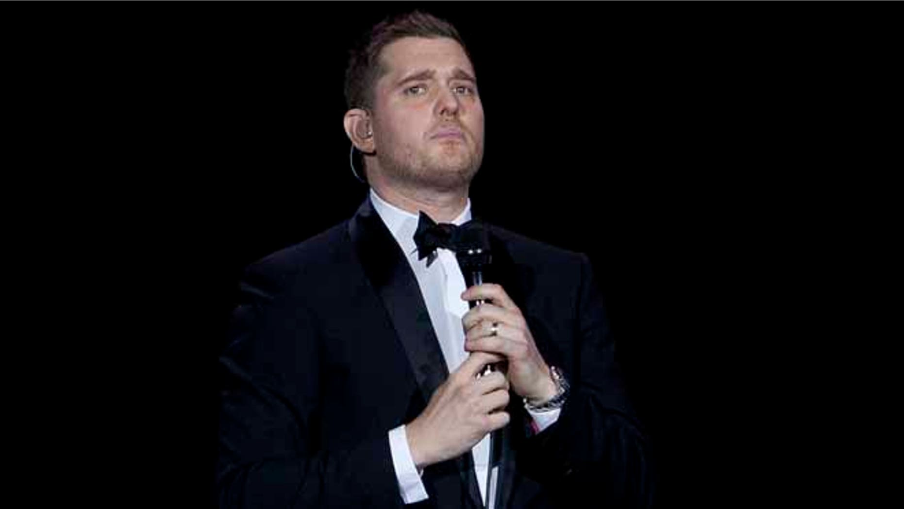 FILE - In this Jan. 31, 2014, file photo, Canadian singer Michael Buble performs during his concert at Palacio de los Deportes in Madrid, Spain. Buble announced on Nov. 4, 2016, that his 3-year-old son has been diagnosed with cancer and is undergoing treatment in the U.S. (AP Photo/Abraham Caro Marin, File)