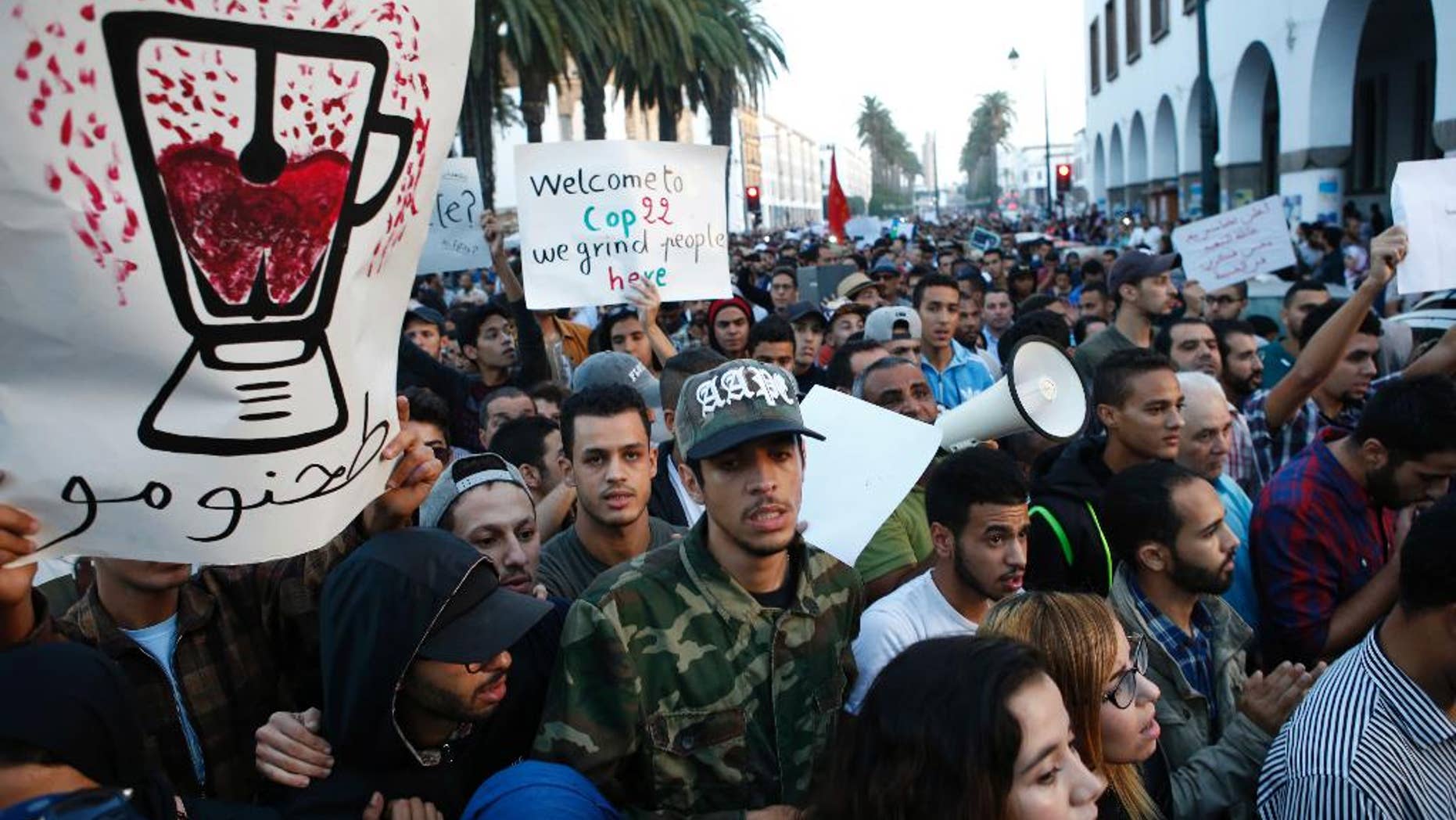 With graphic posters and signs some thousands of Moroccans protest against the death of Mouhcine Fikri last Friday, in the northern city of Hoceima in Rabat, Morocco, Sunday, Oct. 30, 2016. Crowds of Moroccans are protesting, seemingly incensed by the death of a fisherman crushed to death in a garbage truck. (AP Photo/Abdeljalil Bounhar)