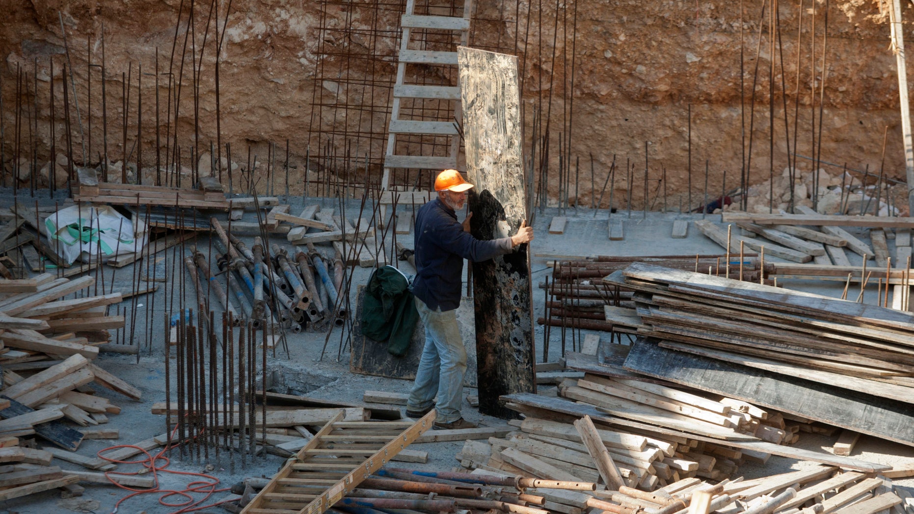 A Palestinian worker is seen on a construction site in the east Jerusalem neighborhood of Ramat Sholmo, Tuesday, Dec. 18, 2012. A European diplomat says Germany and three other European members of the U.N. Security Council are preparing a statement condemning Israel's latest settlement plans in the West Bank.(AP Photo/Dan Balilty)