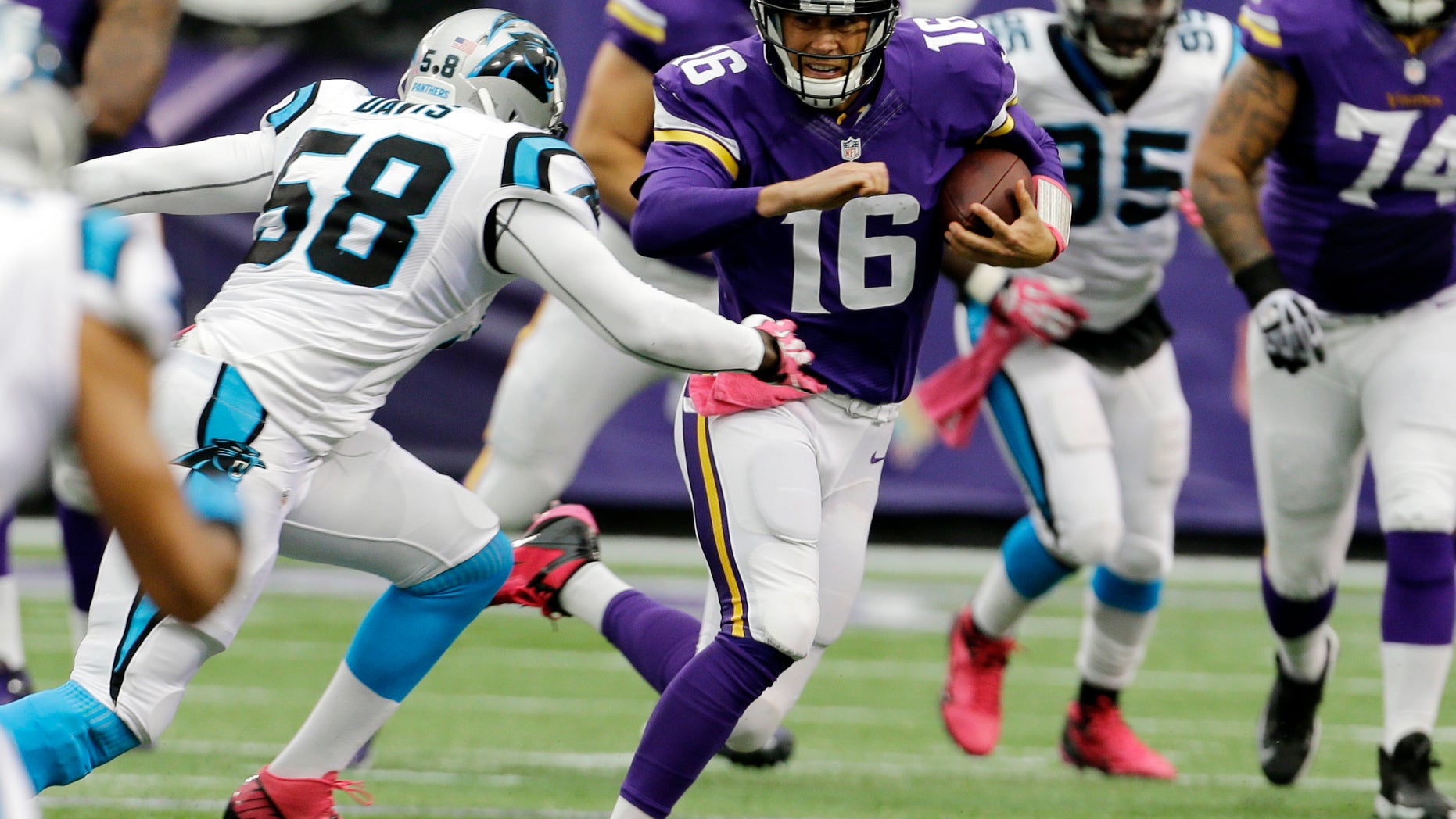 Carolina Panthers outside linebacker Thomas Davis, left, chases down Minnesota Vikings quarterback Matt Cassel (16) as he runs during the first half of an NFL football game in Minneapolis, Sunday, Oct. 13, 2013. (AP Photo/Ann Heisenfelt)