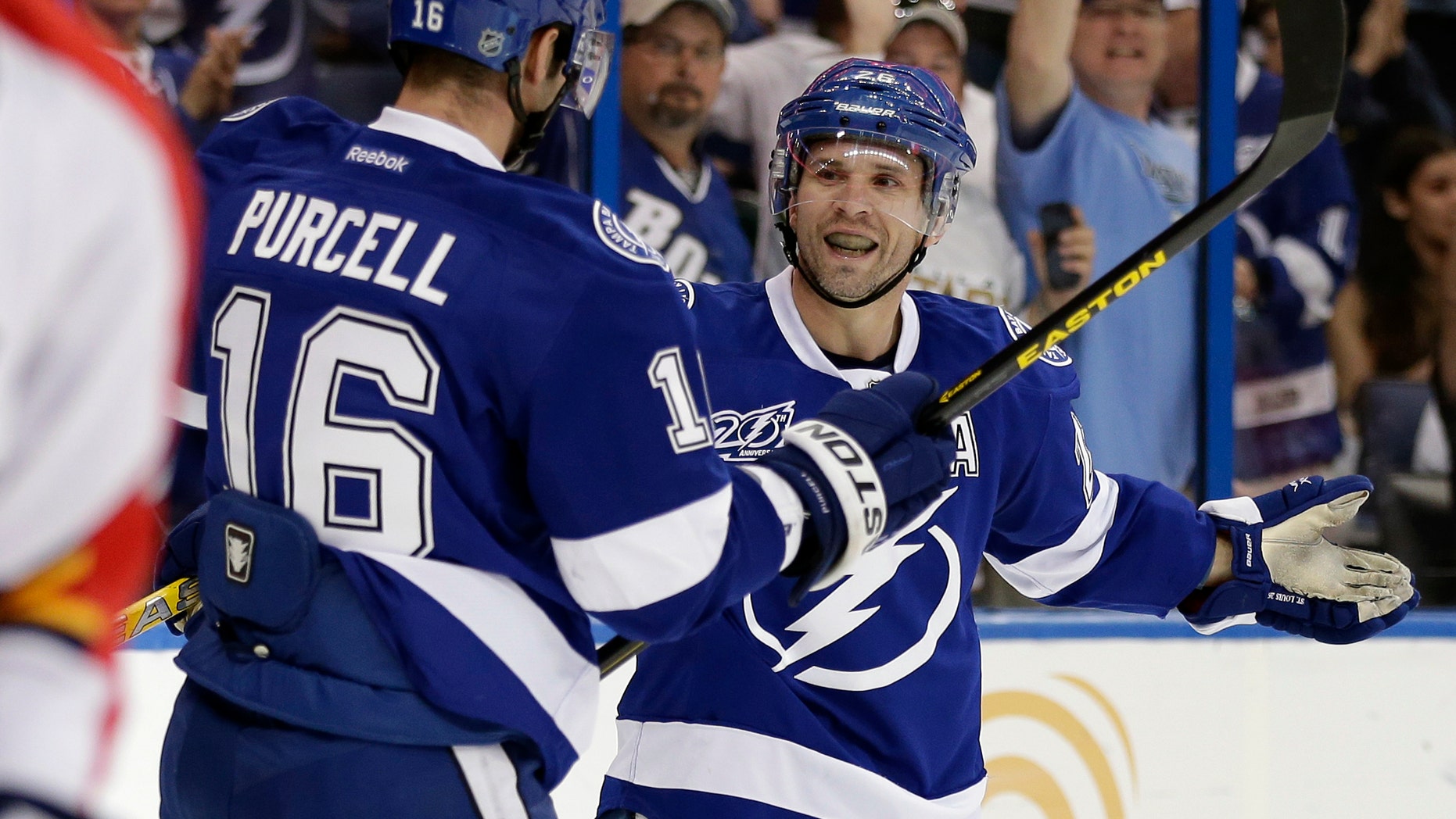 Tampa Bay Lightning right wing Martin St. Louis, right, celebrates with teammate Teddy Purcell after scoring against the Florida Panthers during the second period of an NHL hockey game Saturday, April 27, 2013, in Tampa, Fla. (AP Photo/Chris O'Meara)