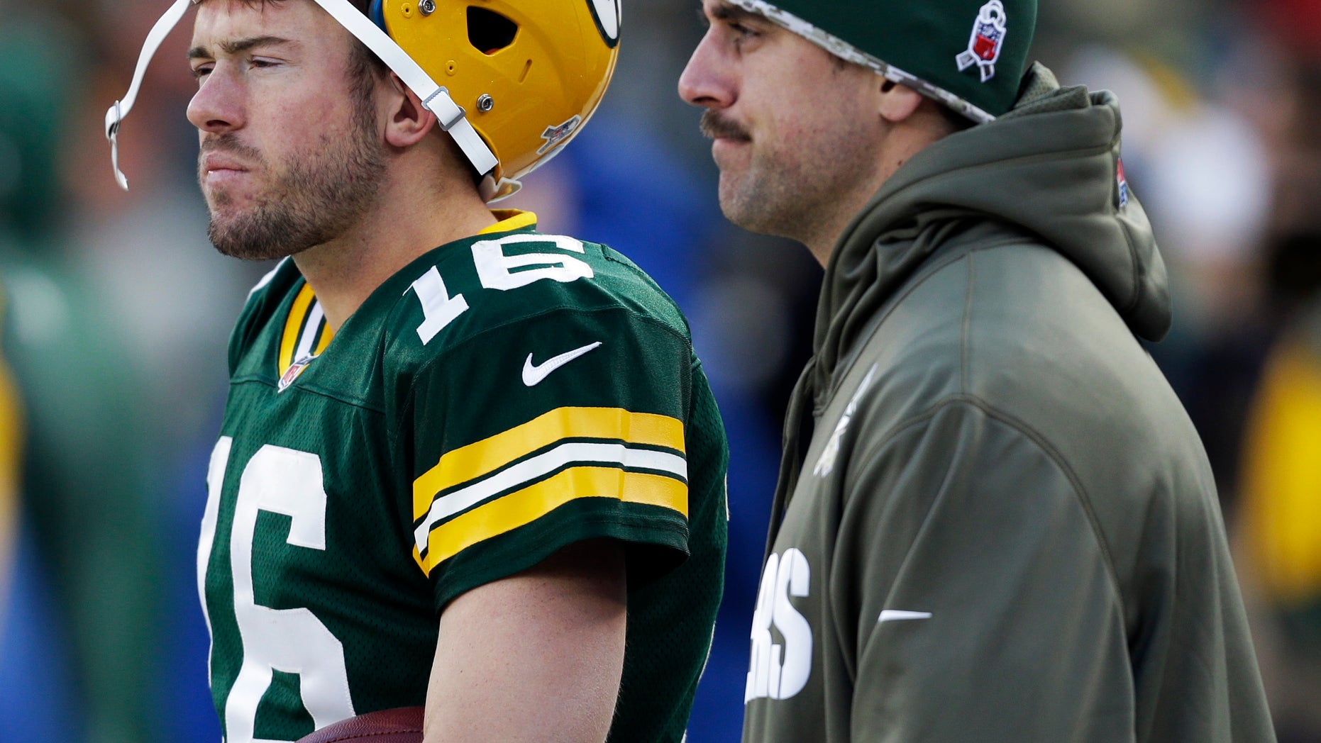 Green Bay Packers' Aaron Rodgers and Scott Tolzien watch from the sidelines during the second half of an NFL football game against the Philadelphia Eagles Sunday, Nov. 10, 2013, in Green Bay, Wis. The Eagles won 27-13. (AP Photo/Mike Roemer)