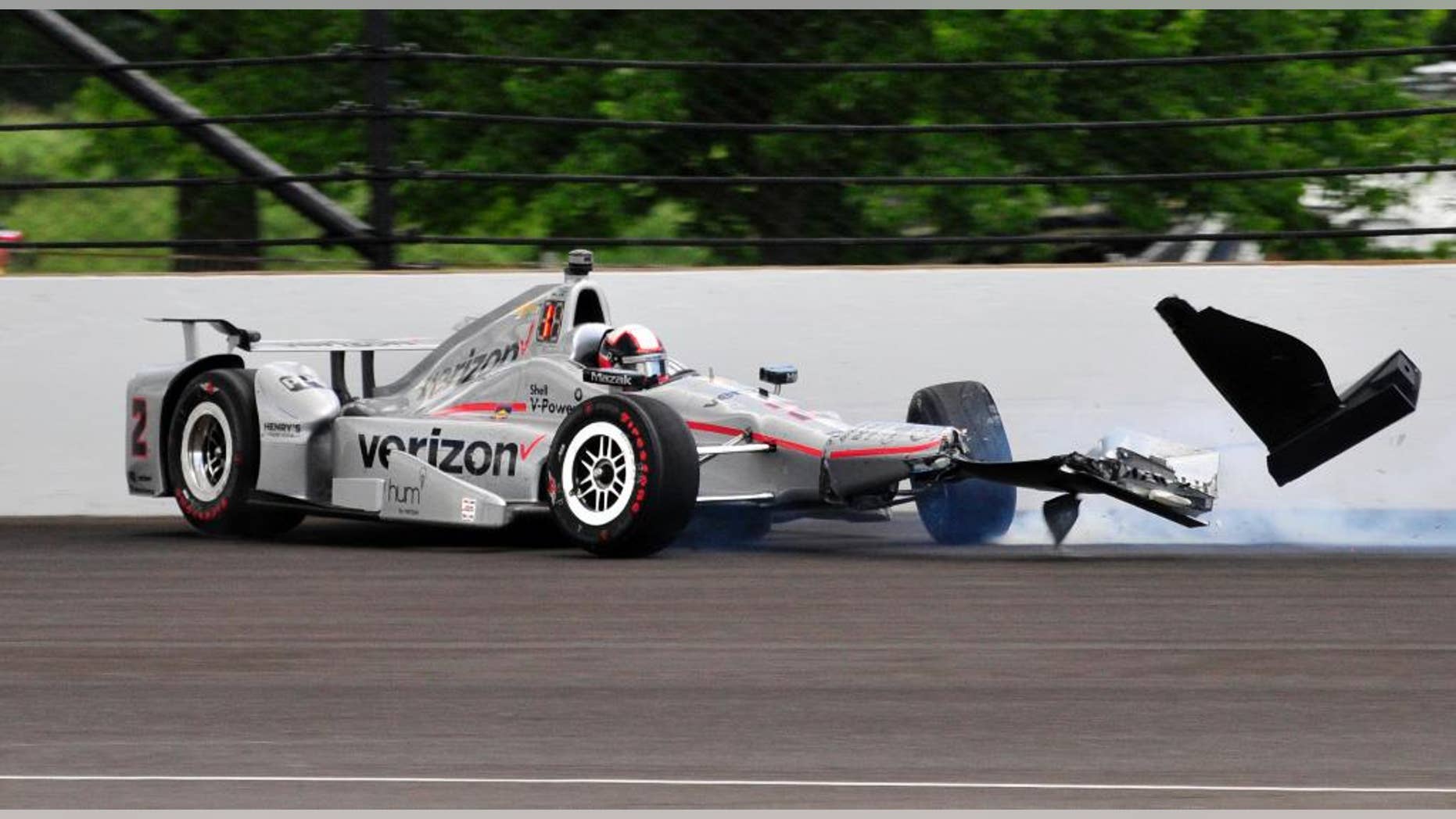 The car driven by Juan Pablo Montoya, of Colombia, hits the wall int he second turn during the 100th running of the Indianapolis 500 auto race at Indianapolis Motor Speedway in Indianapolis, Sunday, May 29, 2016. (AP Photo/John Maxwell)