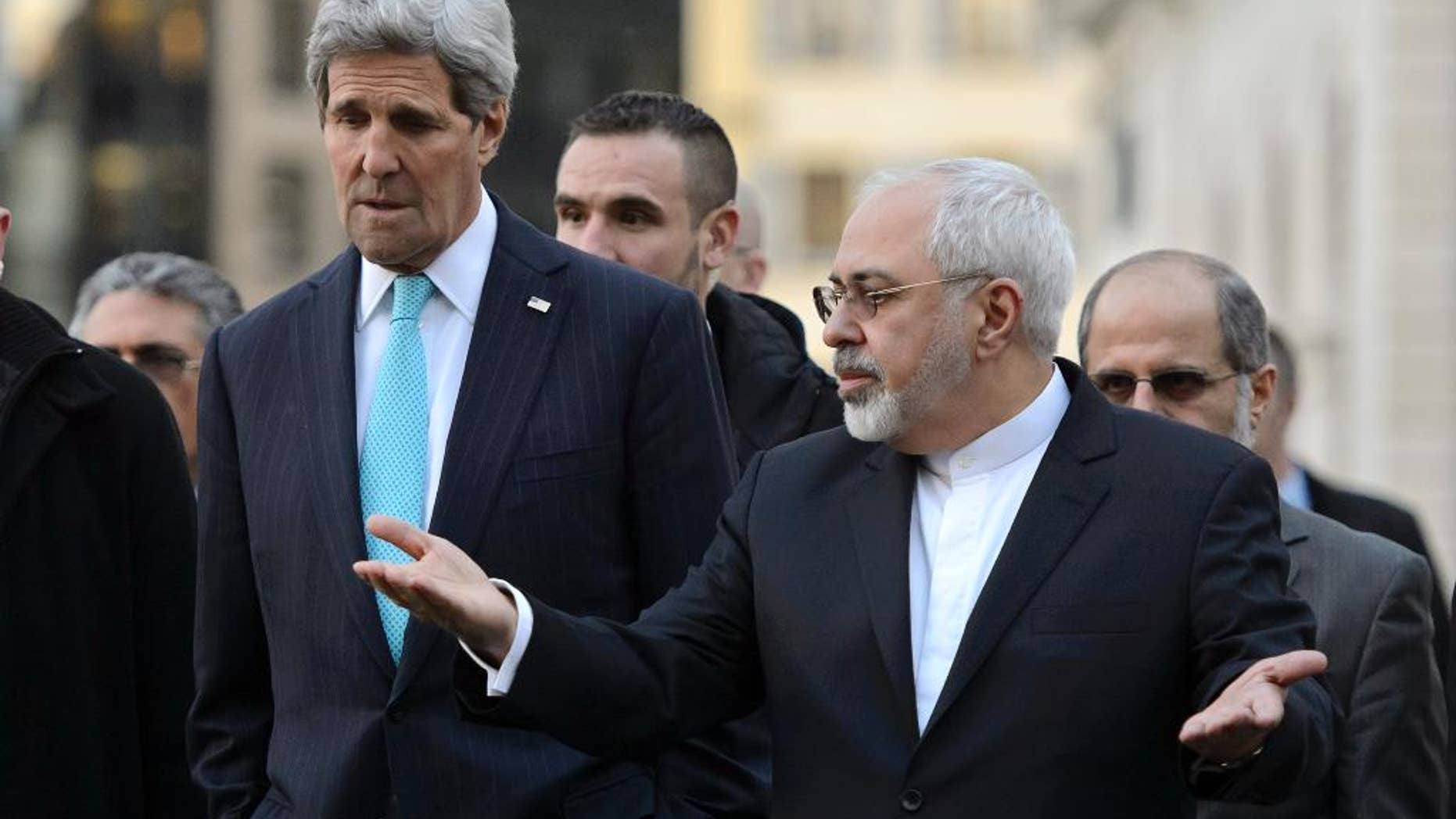 FILE - In this Jan. 14, 2015 file picture US Secretary of State John Kerry, left, listens to Iranian Foreign Minister Mohammad Javad Zarif, as they walk in the city of Geneva, Switzerland, during a bilateral meeting ahead of nuclear discussions. With time for negotiations running short, the U.S and Iran are discussing a compromise that would let Iran keep much of its uranium-enriching technology but reduce its potential to make nuclear weapons, two diplomats tell The Associated Press. (AP Photo/Keystone,Martial Trezzini, File)