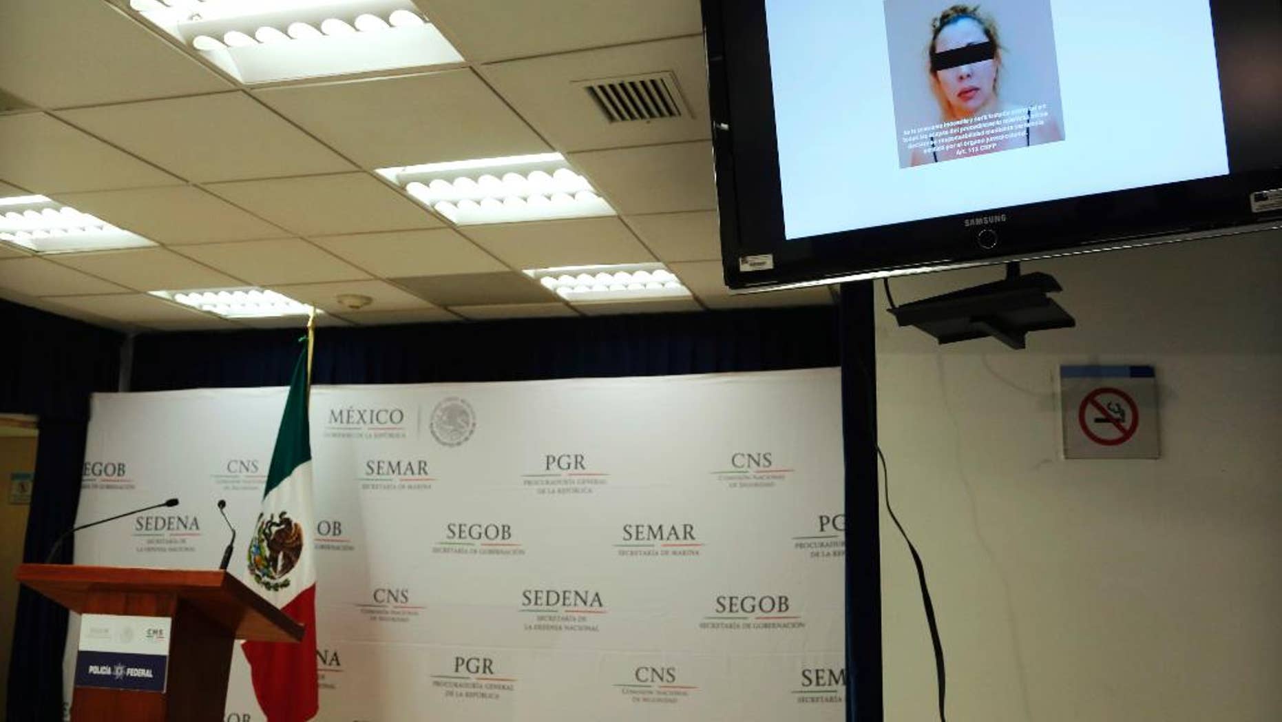 A woman identified by authorities as Clara Laborin Archuleta, wife of jailed drug lord Hector Beltran Leyva, is shown on a monitor during a news conference by federal police in Mexico City, Tuesday, Sept. 13, 2016. Federal police say Archuleta was arrested on Monday in the northern state of Sonora. She's alleged to have been involved in efforts to reassert her husband’s gang’s control over criminal operations in the Pacific coast resort city of Acapulco. (AP Photo/Marco Ugarte)