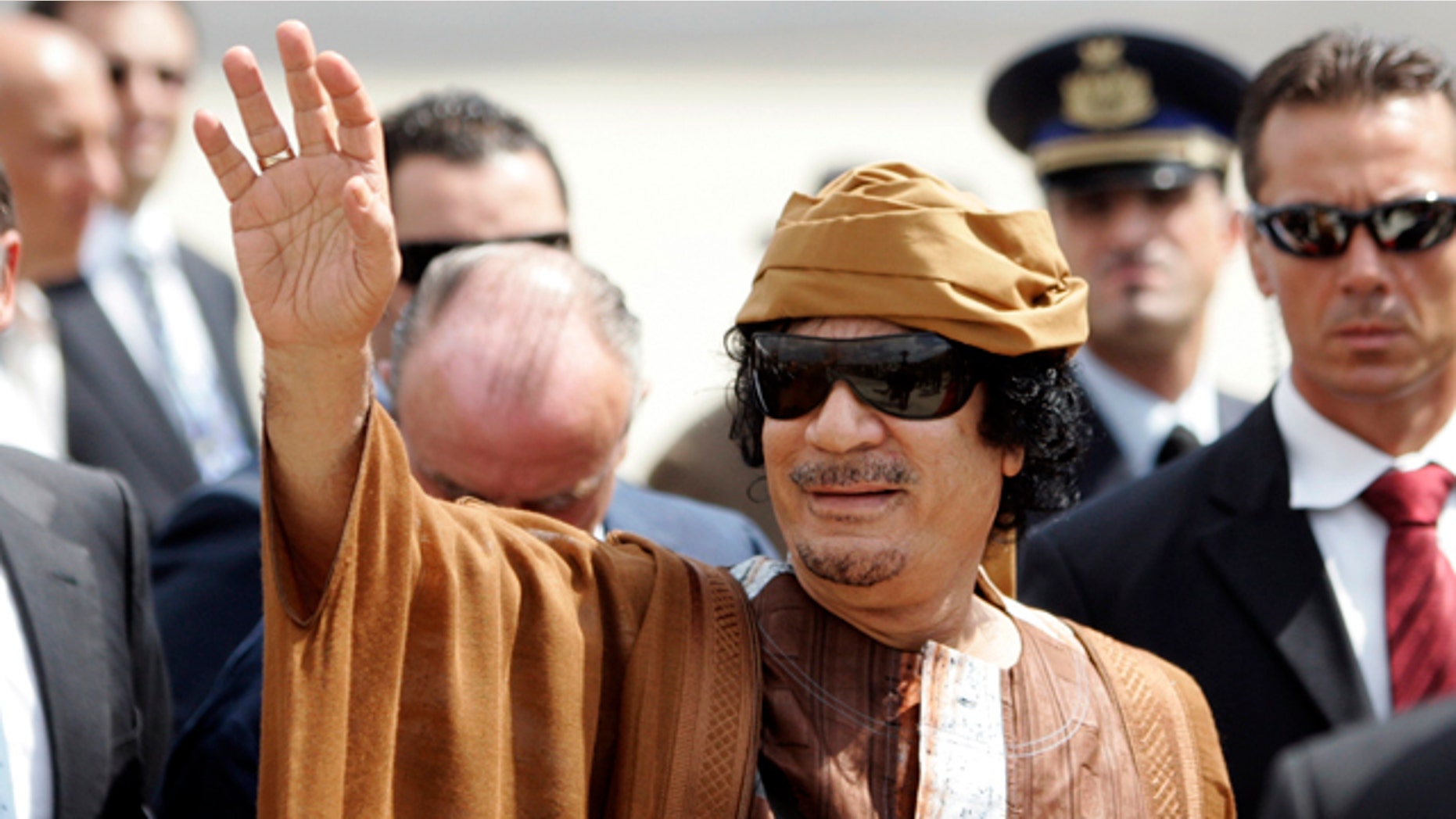 Aug. 29, 2010: Libyan leader Muammar Qaddafi gestures as he arrives at Ciampino airport, near Rome.