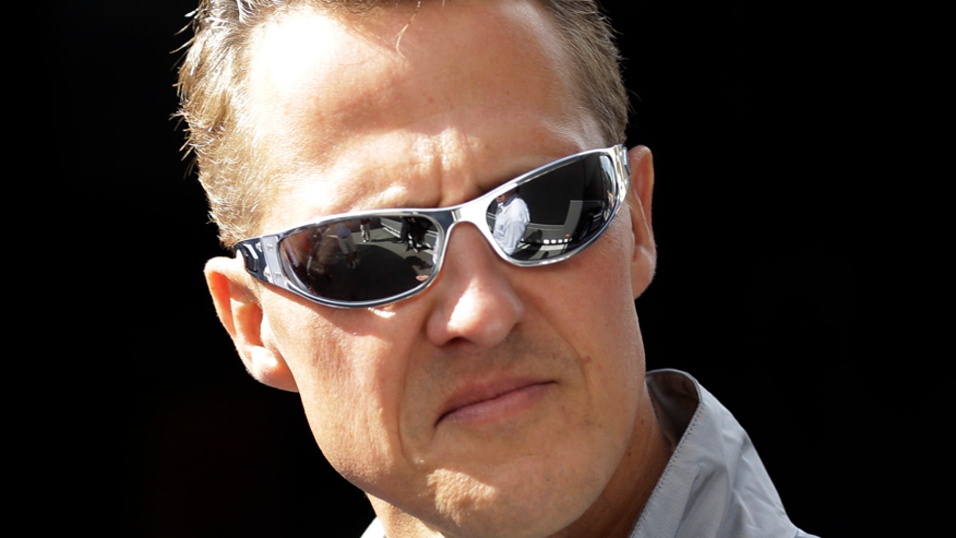 FILE - In this Thursday, Aug. 30, 2012 file photo, former Mercedes Grand Prix driver Michael Schumacher of Germany, looks on ahead the Belgium Formula One Grand Prix in Spa-Francorchamps circuit , Belgium. Former Formula One world champion Michael Schumacher has left hospital to continue his recovery at home, his manager said Tuesday. The seven-time champion suffered a serious head injury while skiing in France in December, resulting in him being put in a coma. (AP Photo/Luca Bruno, File)