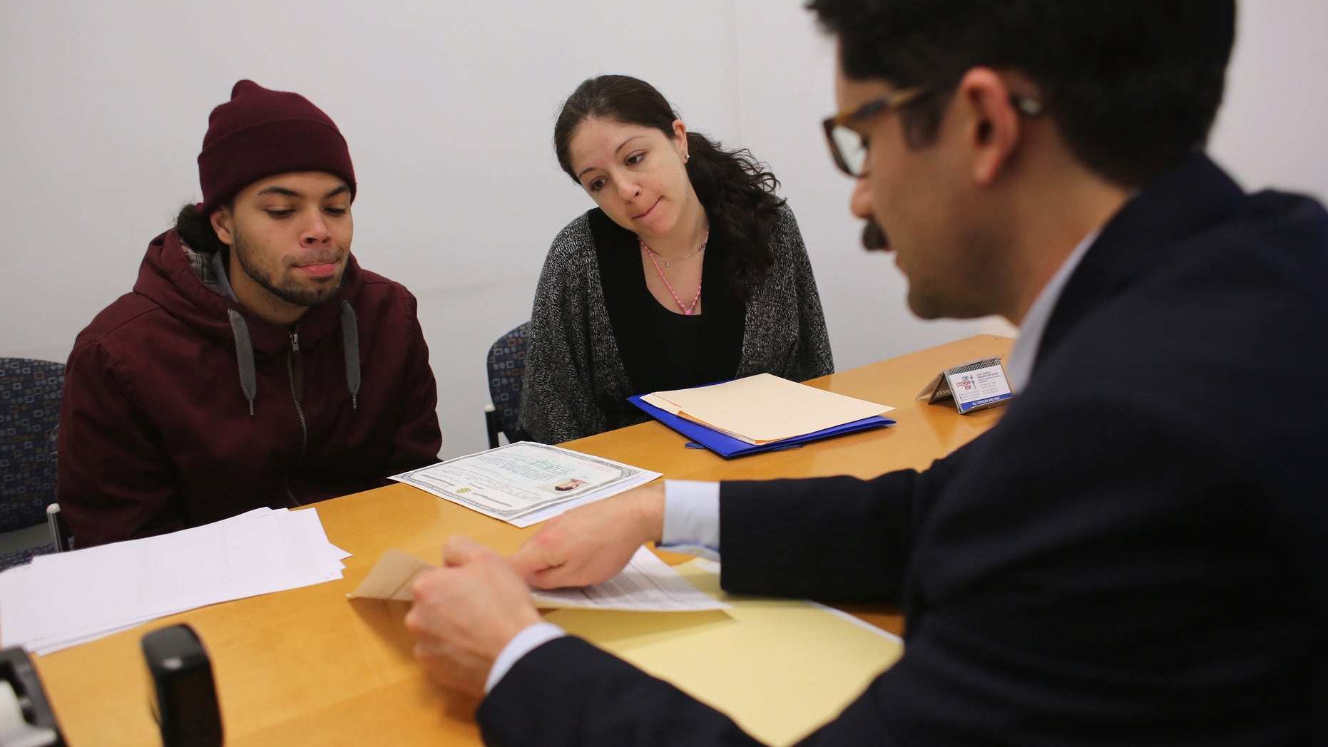 NEW YORK, NY - JANUARY 31: Immigration lawyer Andres Lemons advises Angel and Evie Gomez on their U.S. citizenship application on January 31, 2013 in New York City. The married couple, he from the Dominican Republic, and she from Canada are soon to have a baby and are working through the long process to become U.S. citizens. Lemons works at the CUNY Citizenship Now "Express Center" in New York's Washington Heights. The non-profit helps some 8,000 immigrants in the New York area navigate through the complicated process of acquiring U.S. Citizenship and provides free legal information for the immigrant community. (Photo by John Moore/Getty Images)