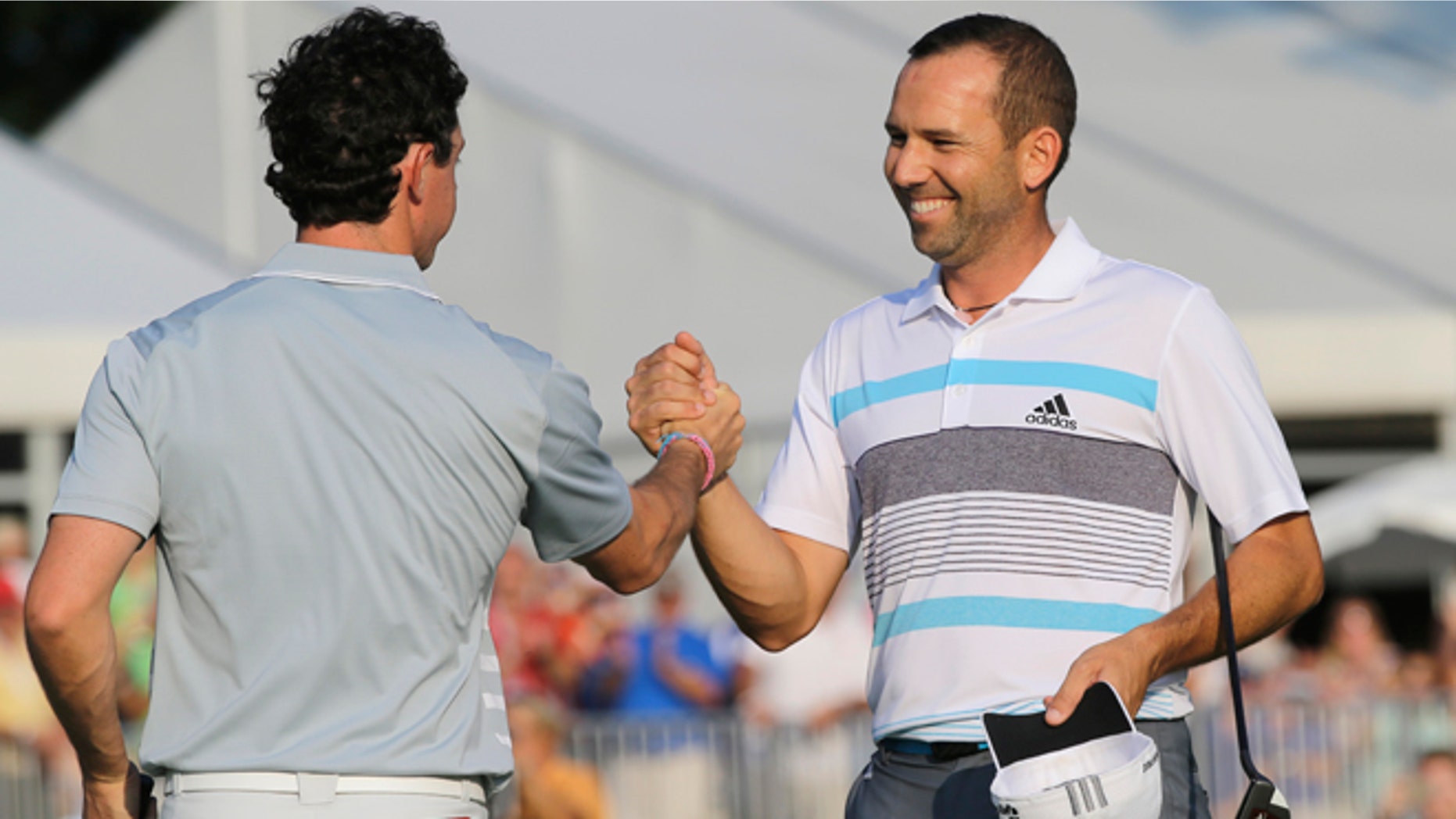 Sergio Garcia, right, congratulates Rory McIlroy after the final round of the Bridgestone Invitational golf tournament Sunday, Aug. 3, 2014, at Firestone Country Club in Akron, Ohio. McIlroy beat Garcia by two shots for the championship. (AP Photo/Mark Duncan)