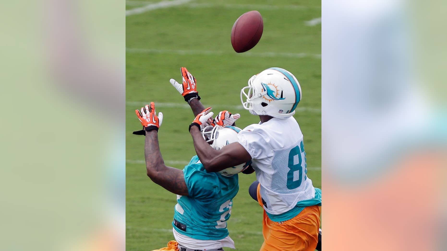 Miami Dolphins cornerback Jamar Taylor, left, breaks up a pass intended for wide receiver Stephen Williams during NFL football mini camp, Wednesday, June 18, 2014, in Davie, Fla. Taylor has pulled ahead of his teammate Will Davis by earning snaps opposite Pro Bowl cornerback Brent Grimes on the first-team defense. He appears to be fully recovered from the sports hernia injury that affected him as a rookie. (AP Photo/Wilfredo Lee)