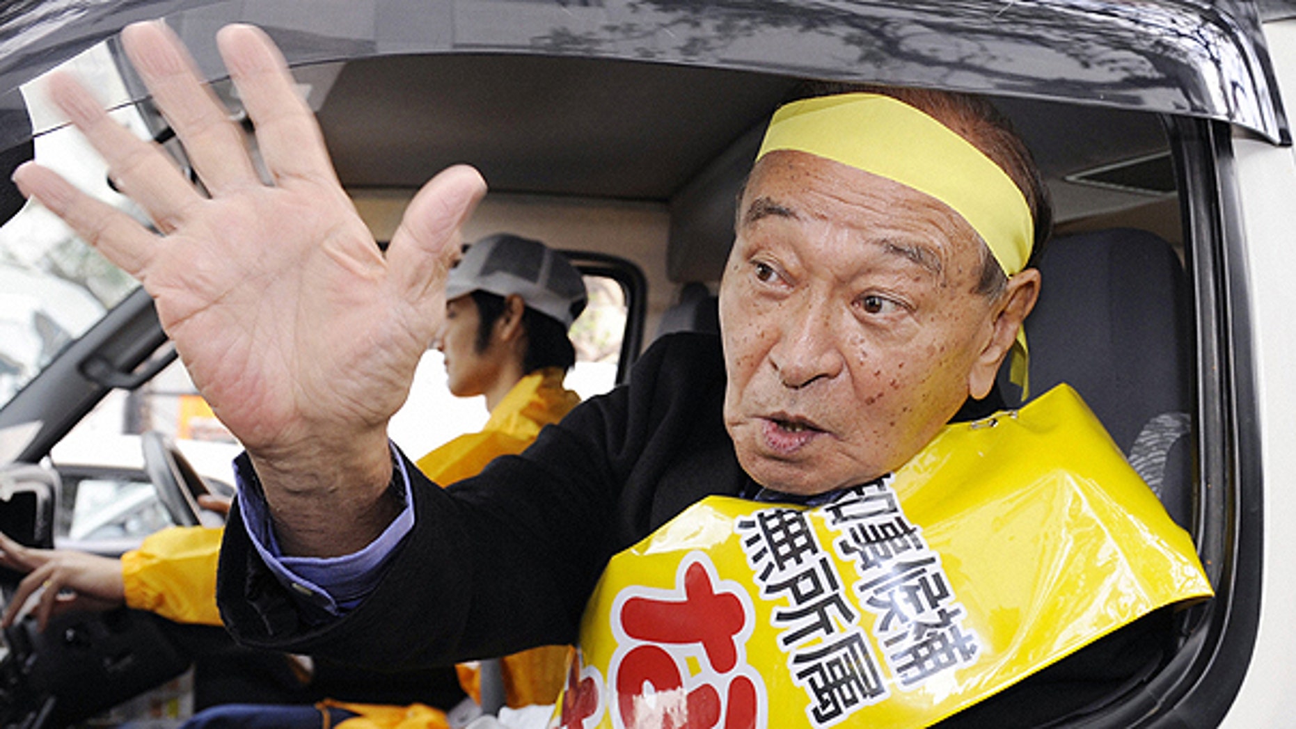 Nov. 11: Incumbent Okinawa Gov. Hirokazu Nakaima waves from a vehicle during his campaign for the Nov. 28 Okinawa gubernatorial election in Naha, Okinawa Prefecture, southern Japan.