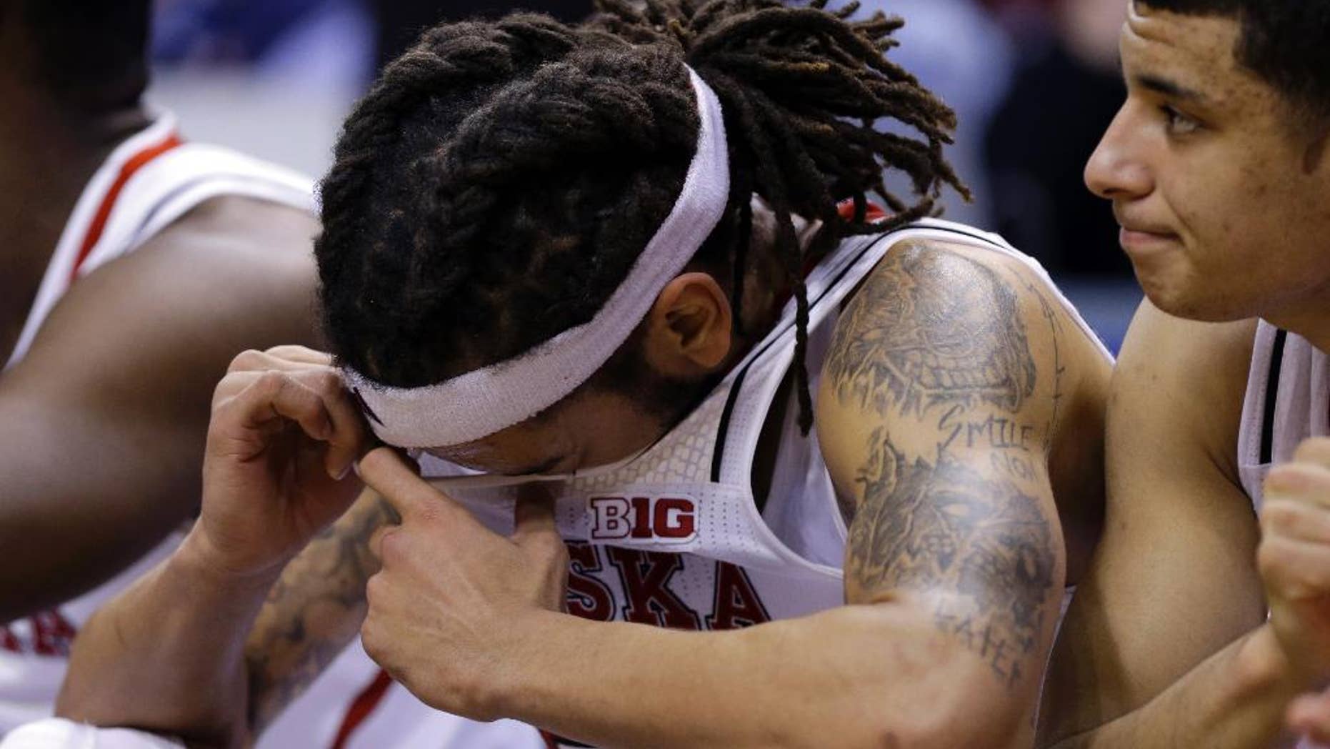 Nebraska forward Terran Petteway wipes his face on the bench in the second half of an NCAA college basketball game against Ohio State in the quarterfinals of the Big Ten Conference tournament Friday, March 14, 2014, in Indianapolis. Ohio State won 71-67. (AP Photo/Michael Conroy)