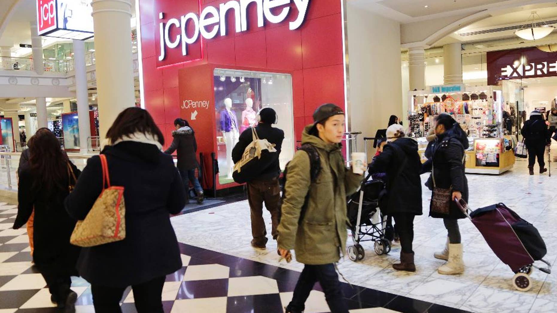 In this Feb. 19, 2015 photo, shoppers visit a J.C. Penney store, in New York. The Texas-based retailer reports quarterly financial results after the market closes Thursday, Feb. 26, 2015. (AP Photo/Mark Lennihan)