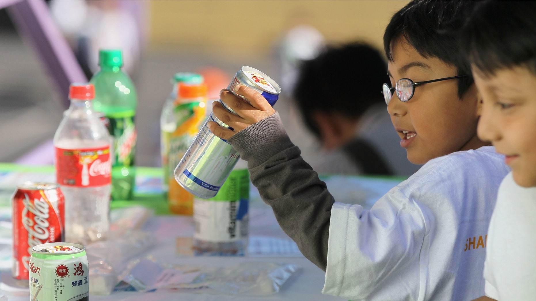 SAN FRANCISCO - NOVEMBER 12: A student at Fairmount Elementary School looks at a display showing how much sugar is in soft drinks and juices on November 12, 2010 in San Francisco, California. (Photo by Justin Sullivan/Getty Images)