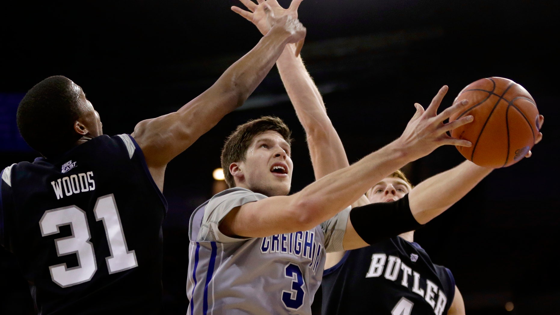 Creighton's Doug McDermott (3) goes for a layup against Butler's Kameron Woods (31) and Erik Fromm (4) in the second half of an NCAA college basketball game in Omaha, Neb., Tuesday, Jan. 14, 2014. Creighton won 88-60. (AP Photo/Nati Harnik)