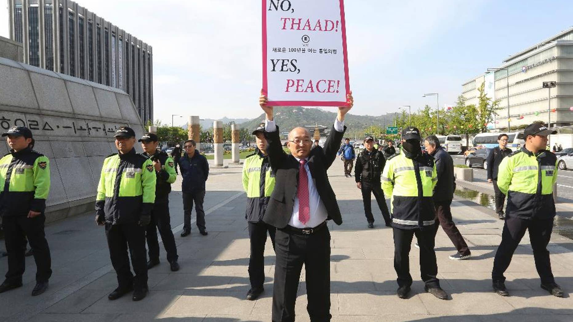 A South Korean protester holds up a placard opposing a plan to deploy the advanced U.S. missile defense system called Terminal High-Altitude Area Defense, or THAAD, near U.S. Embassy in Seoul, South Korea, Thursday, April 27, 2017. In a defiant bit of timing, South Korea announced Wednesday that key parts of a contentious U.S. missile defense system had been installed a day after rival North Korea showed off its military power. (AP Photo/Ahn Young-joon)
