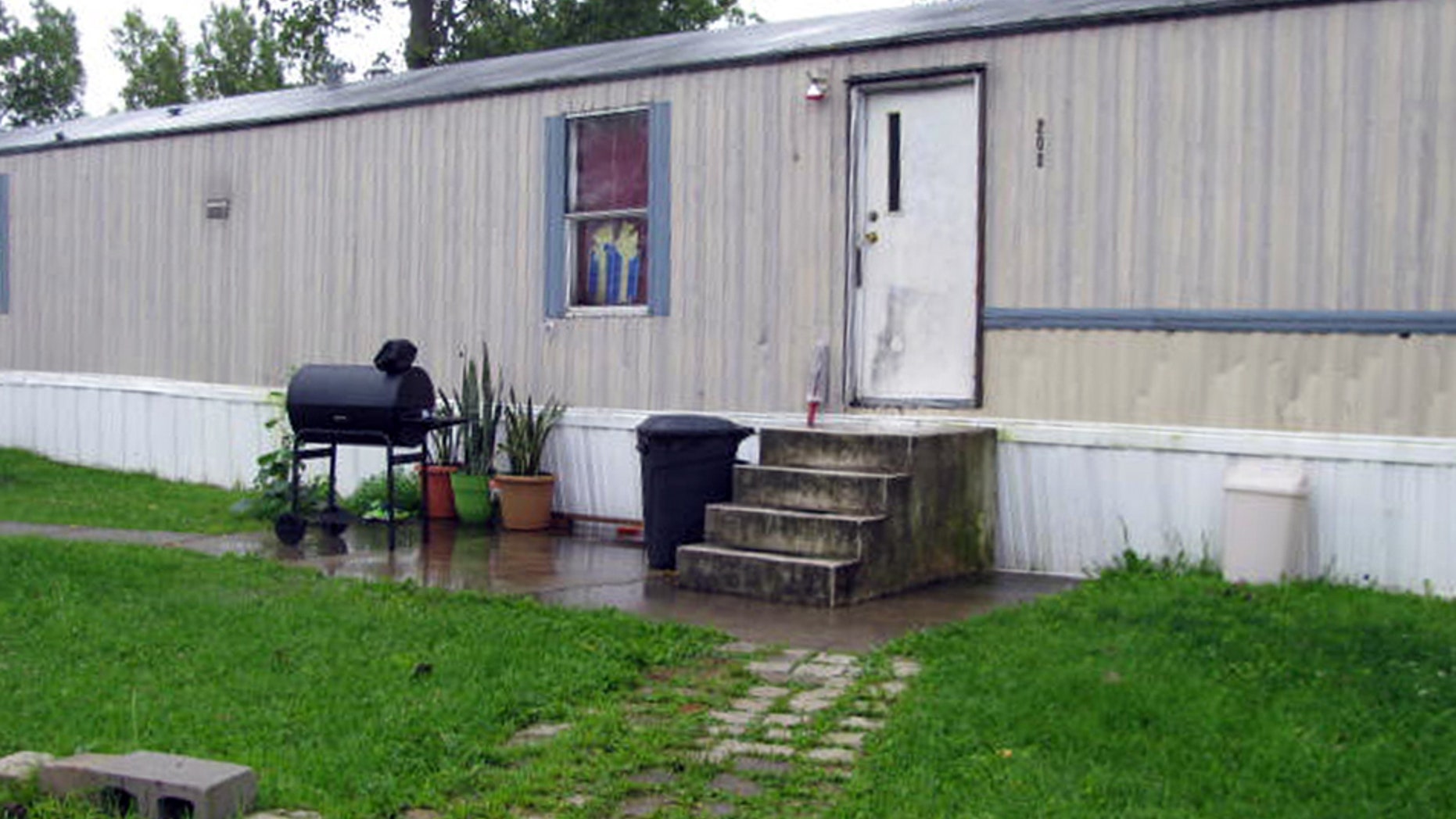 This photo taken July 17, 2015 shows a mobile home that prosecutors say Guatemalan teenagers were forced to live in when they weren’t working at egg farms in Marion, Ohio. Prosecutors say immigrant teenagers brought to Ohio and forced to work long hours on egg farms had been fraudulently plucked from U.S. custody after arriving at the border. (AP Photo/Mitch Stacy)