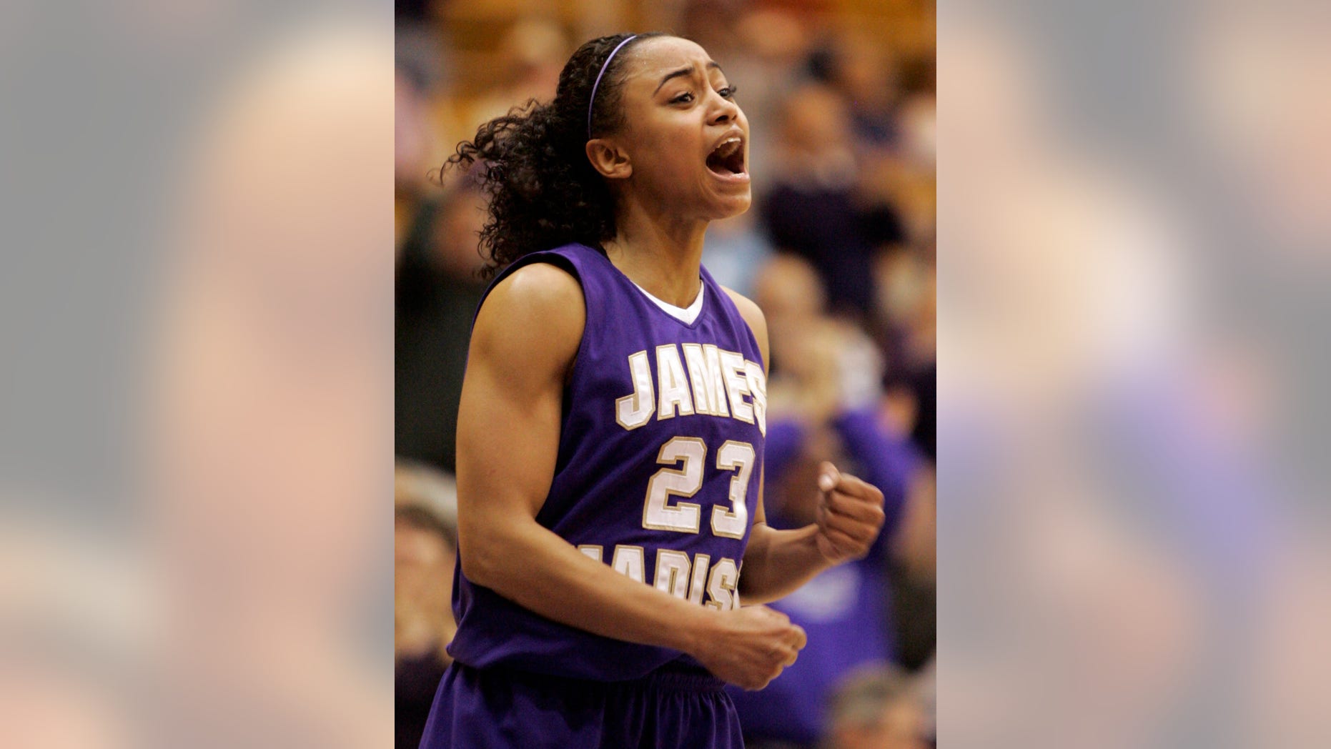 FILE - In this March 14, 2009, file photo, James Madison guard Dawn Evans rallies her team during second half of an NCAA college basketball game in Harrisonburg, Va. Evans, one of the nation's leading scorers for three years as a point guard at James Madison, has left her professional team in France and returned to Tennessee to prepare for a kidney transplant. (AP Photo/Steve Helber, File)