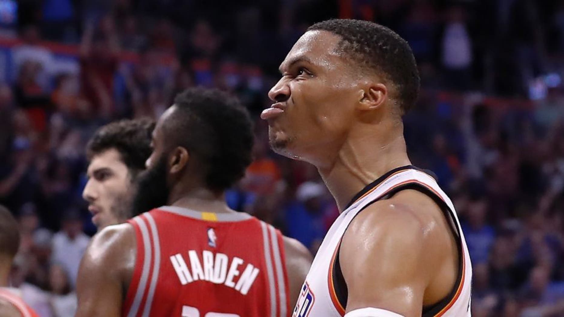 Oklahoma City Thunder guard Russell Westbrook (0) reacts after dunking against the Houston Rockets during the second half of an NBA basketball game in Oklahoma City, Wednesday, Nov. 16, 2016. Oklahoma City won 105-103. (AP Photo/Alonzo Adams)