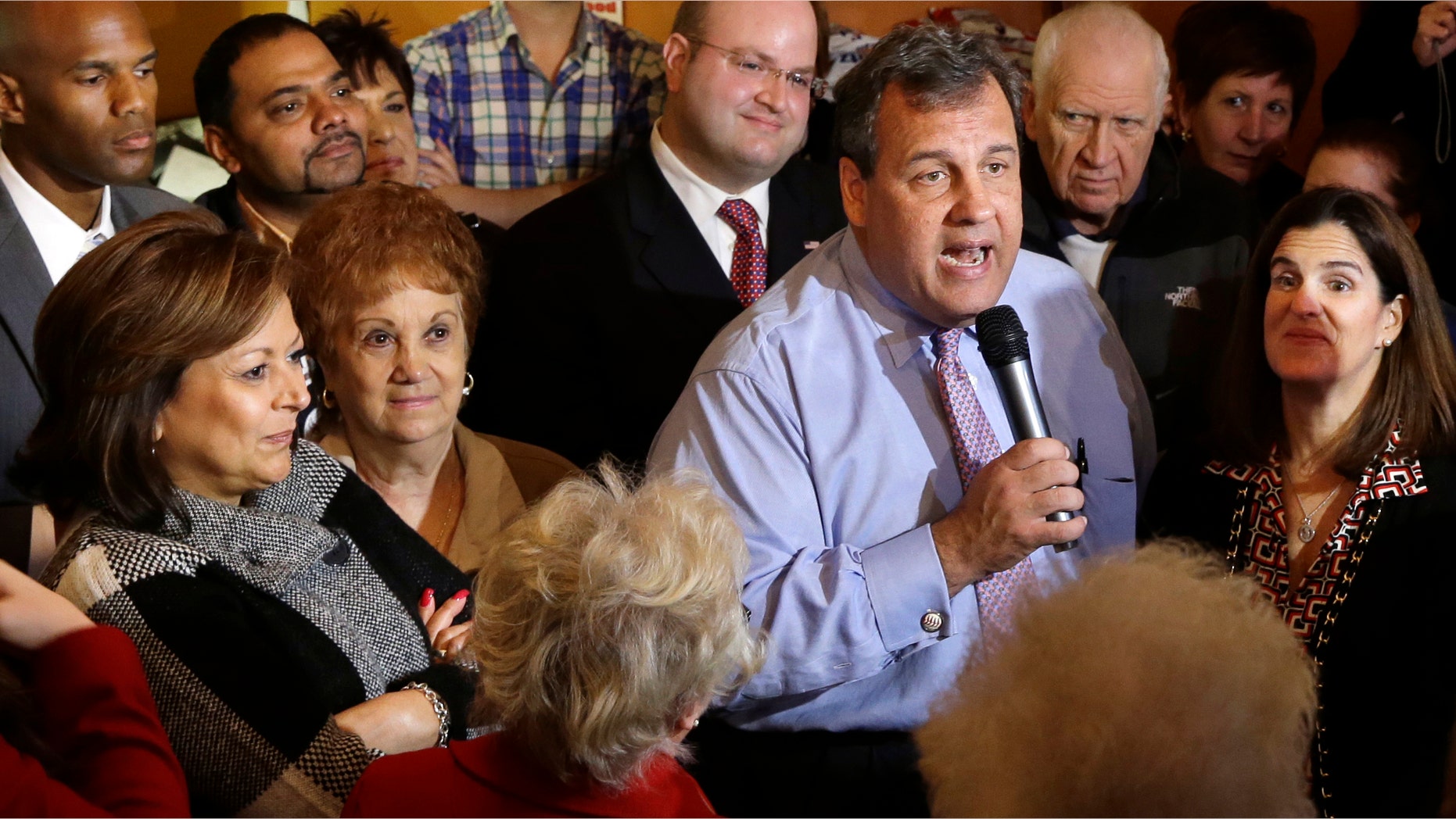 New Mexico Governor Susana Martinez, left, listens along with New Jersey first lady Mary Pat Christie, right, as New Jersey Gov. Chris Christie greets supporters during a campaign stop in Hillside, N.J., Monday, Nov. 4, 2013. Christie will face Democratic candidate, Barbara Buono in an election Tuesday, Nov. 5, 2013. (AP Photo/Mel Evans)