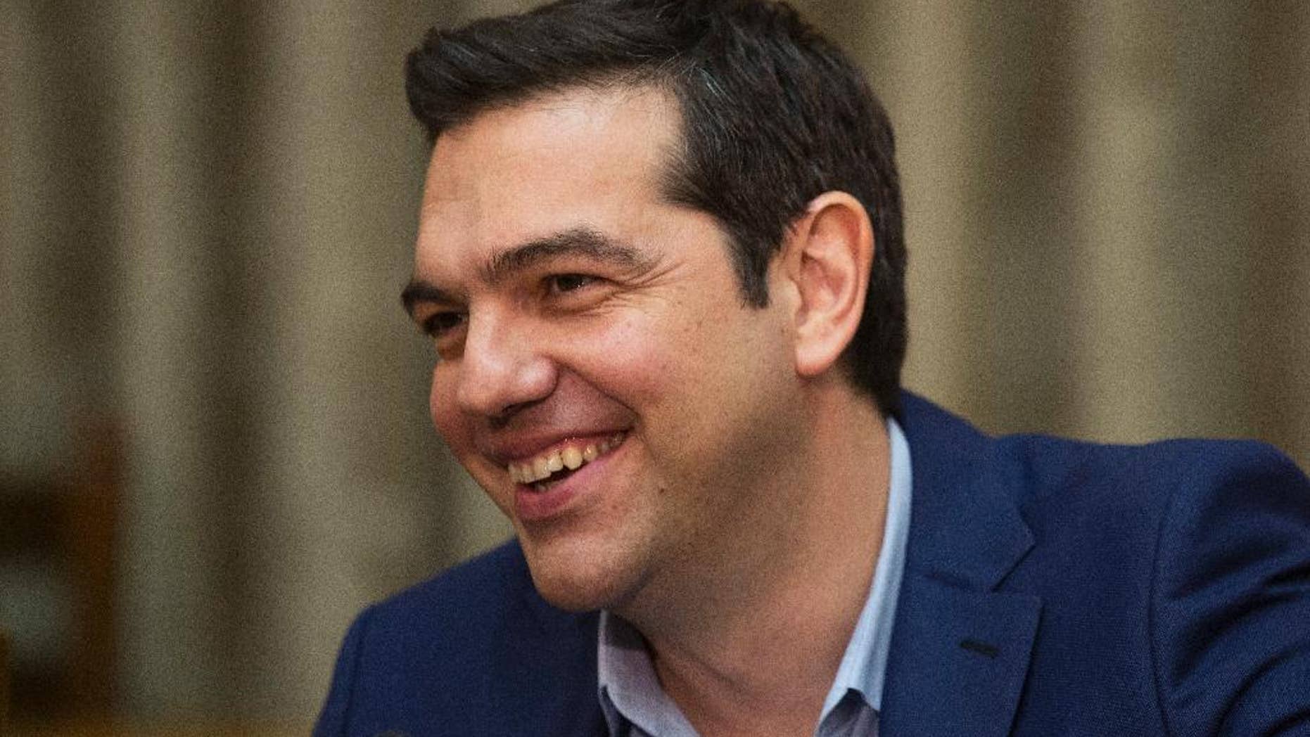 Greek PrIme minister Alexis Tsipras smiles during a cabinet meeting on Thursday, June 2, 2016. Parliament approved a final round of austerity measures Thursday demanded by lenders for the release of further bailout loan installments. (AP Photo/Petros Giannakouris)