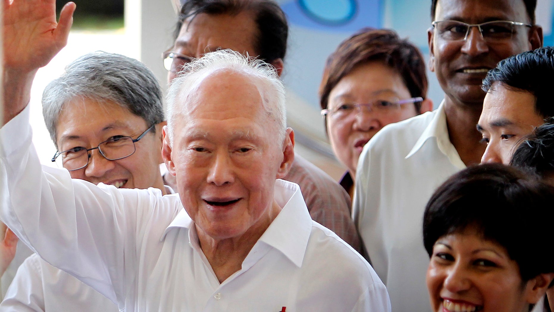 FILE - In this April 27, 2011 file photo, Singapore's Minister Mentor Lee Kuan Yew waves to supporters as he arrives at an elections nomination center in Singapore. A statement from the Prime Minister's Office says the 89-year-old Lee was admitted to Singapore General Hospital on Friday, FEB. 15, 2013, after experiencing a suspected transient ischaemic attack, which occurs when blood flow to the brain stops for a period of time. The condition is associated with irregular heartbeats. (AP Photo/Wong Maye-E, File)