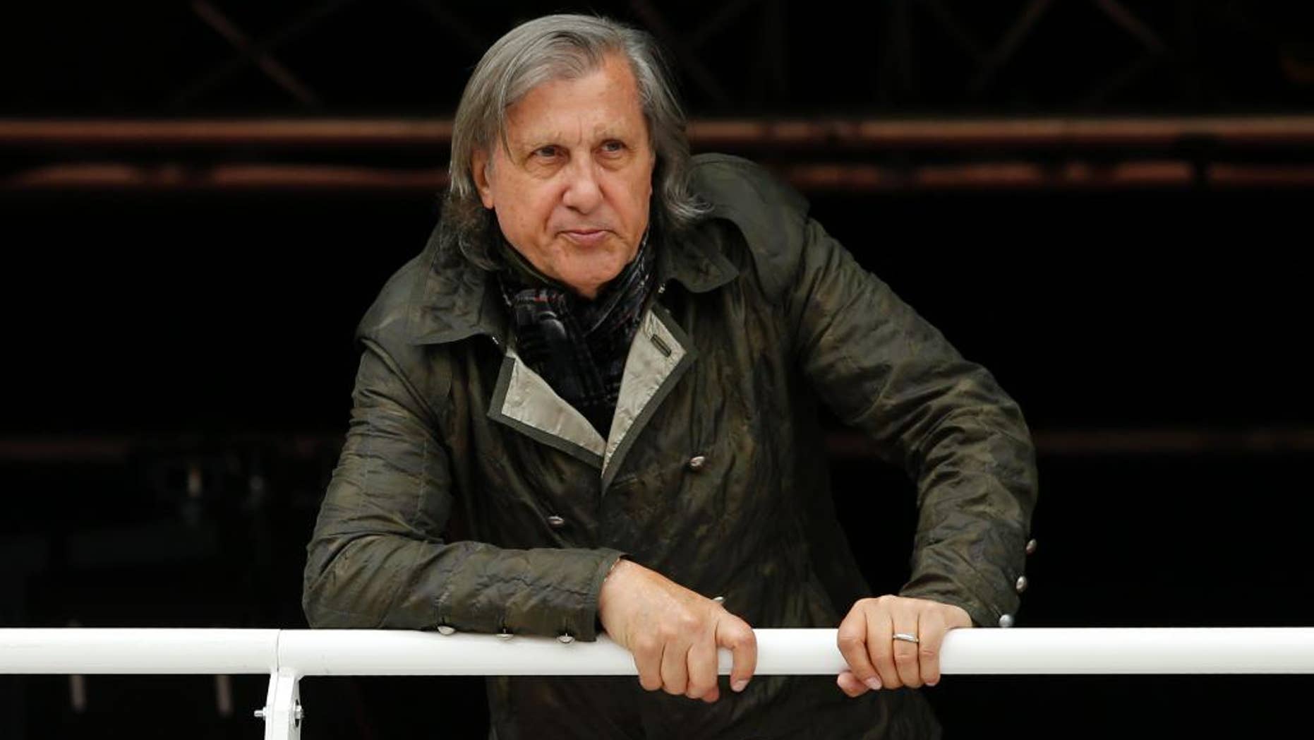 FILE - In this Monday, May 23, 2016 file picture, former Romanian tennis ace Ilie Nastase watches a match of the French Open tennis tournament at the Roland Garros stadium, in Paris, France. Ilie Nastase has received Romania's highest award, the Star of Romania, on his 70th birthday from President Klaus Iohannis for services to sport in Bucharest, Romania, Tuesday, July 19, 2016. (AP Photo/Alastair Grant, File)