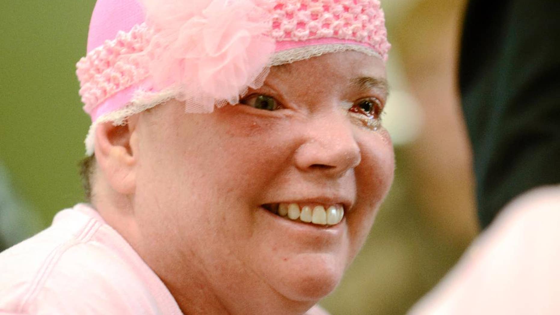 FILE - In this Oct. 21, 2014, file photo, Sharon Budd speaks with her husband, Randy, after being discharged from Geisinger Health South Rehabilitation Hospital in Danville, Pa. Budd was struck by a rock dropped from a bridge overpass onto her vehicle in July 2014. Budd said she wants the three teenage suspects to be tried as adults. (AP Photo/Ralph Wilson, File)
