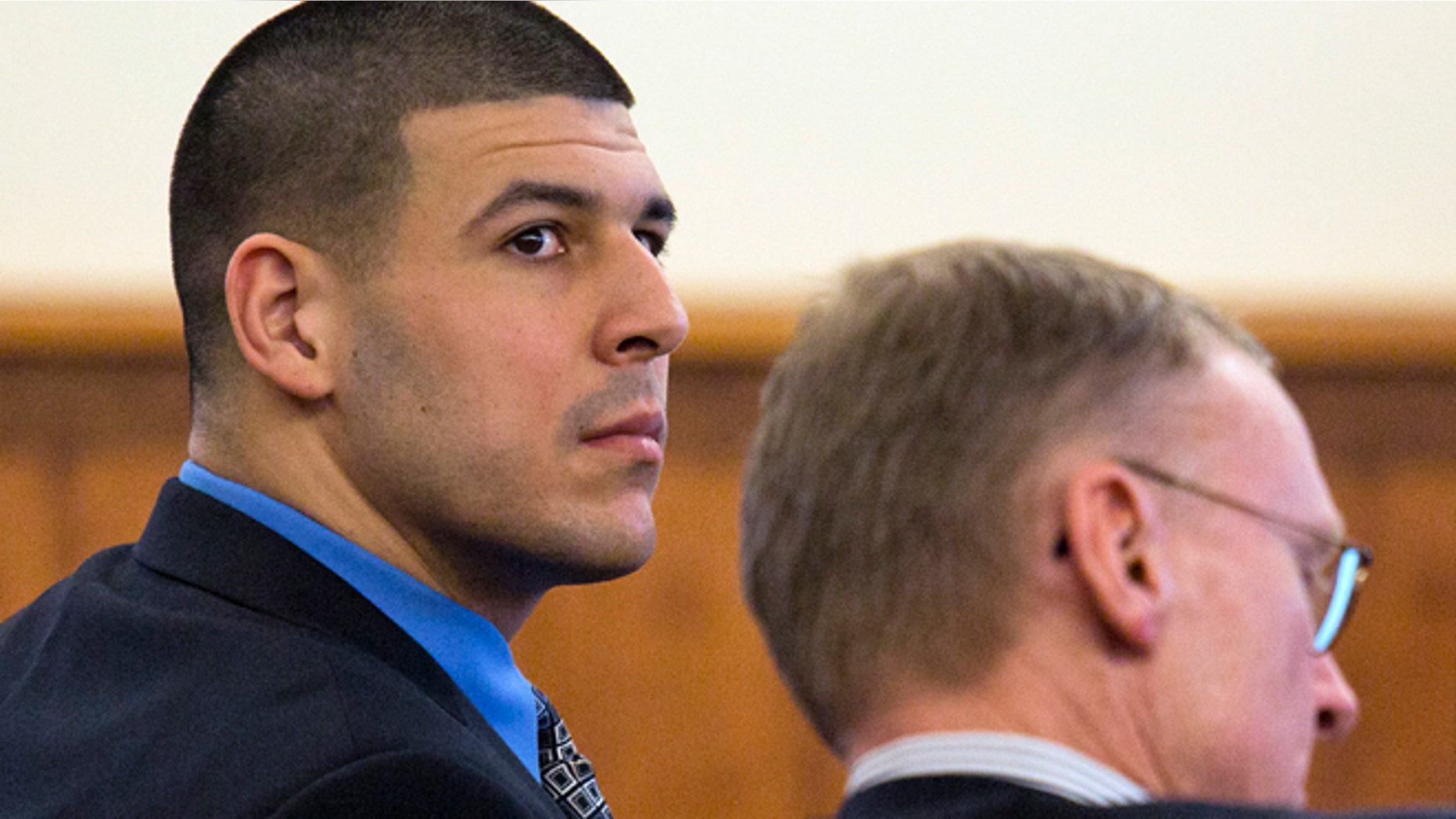 March 11, 2015: Former New England Patriots football player Aaron Hernandez, left, looks back as he sits with his defense attorney Charles Rankin during his murder trial at Bristol County Superior Court.