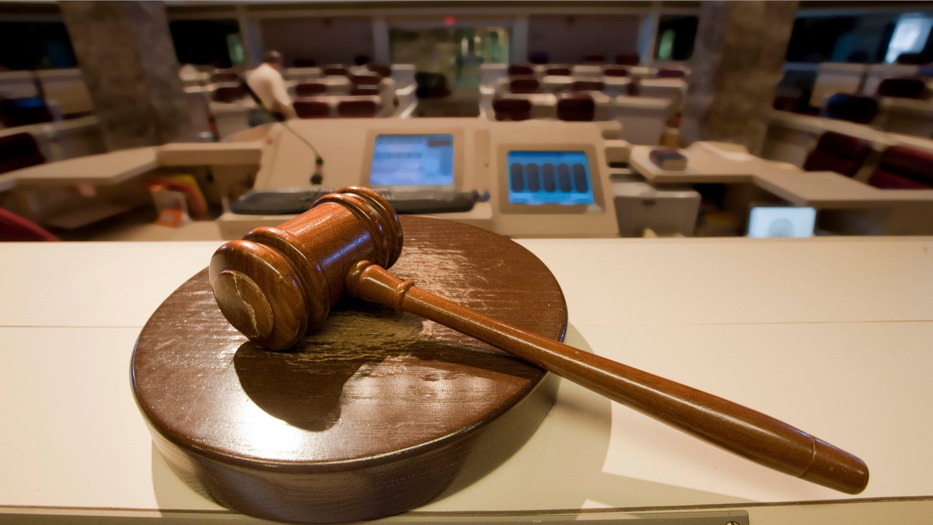 The gavel stands ready as Alabama House Public Information Officer Clay Redden, rear, makes preparations House chamber in Montgomery, Ala., on Friday, Dec. 3, 2010 a for the special session on ethics legislation called by Gov. Bob Riley. The lawmakers come into session next Wednesday. (AP Photo/Dave Martin)