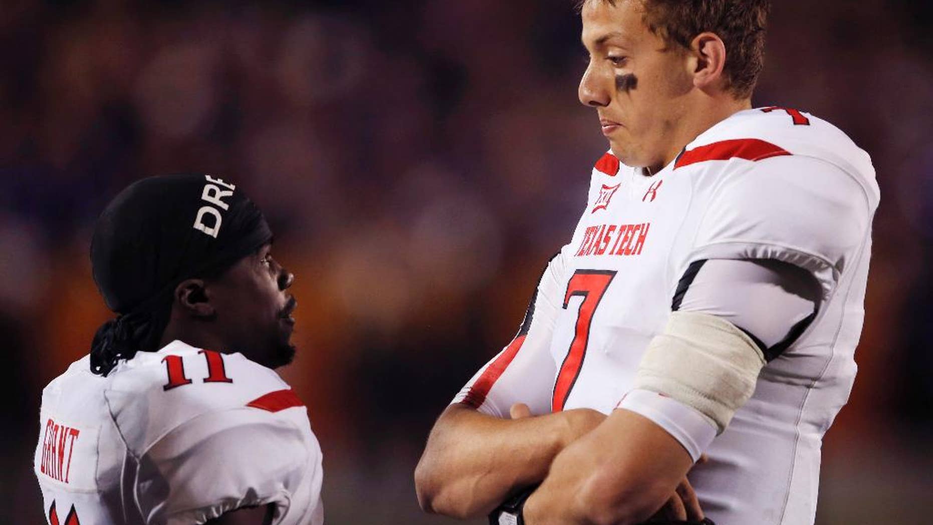 Texas Tech quarterback Davis Webb (7) talks with wide receiver Jakeem Grant (11) during a play review in the second half of an NCAA college football game against Kansas State in Manhattan, Kan., Saturday, Oct. 4, 2014. (AP Photo/Orlin Wagner)