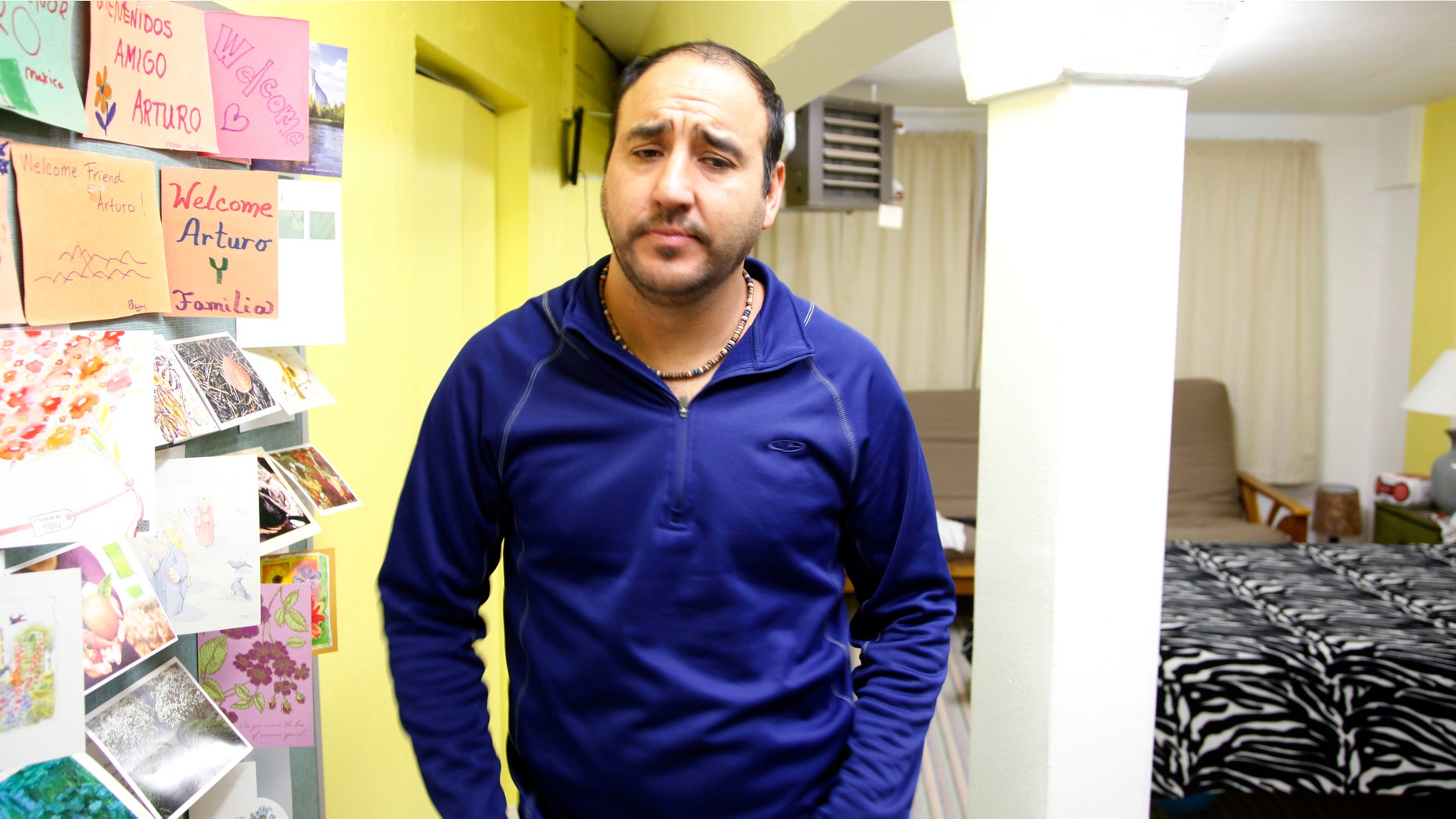 Arturo Hernandez stands in his one-room basement dwelling in Denver on Friday, Nov. 21, 2014. The Mexican man who is living in a Denver church basement to avoid a deportation order says that he is afraid to leave because he does not know if he is covered by President Obama's executive order on immigration. (AP Photo/P. Solomon Banda)