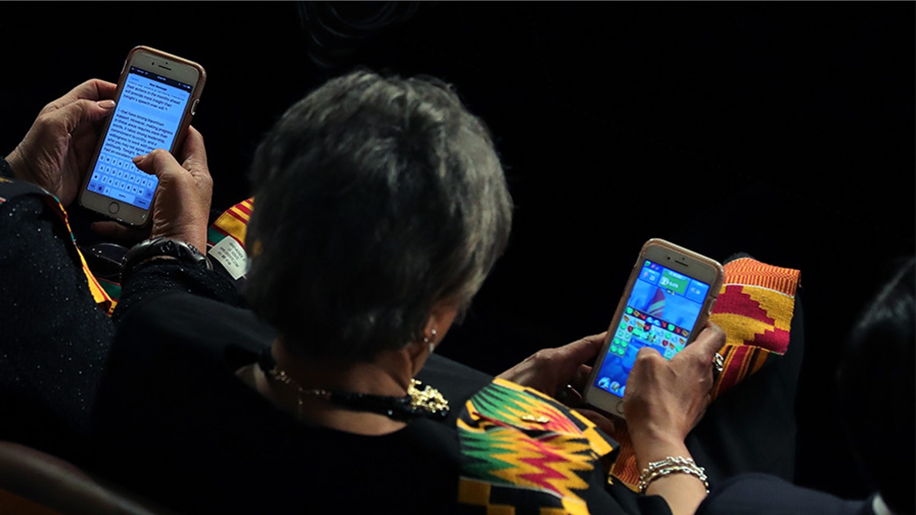 Members of Congress look at their cell phones during the State of the Union address.