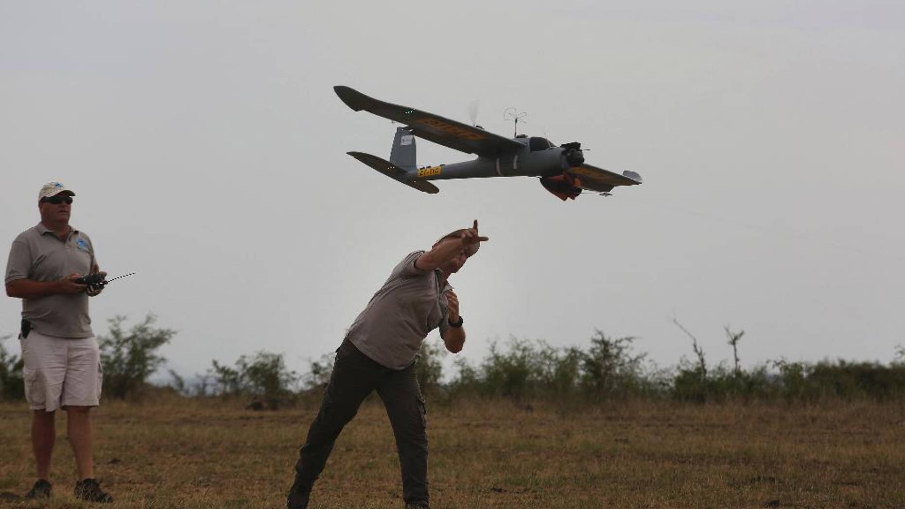 FILE -- In this file photo taken Monday, Feb. 15, 2016 a drone is launched in the Hluhluwe-iMfolozi Game Reserve in the KwaZulu Natal province. Conservationists say Zimbabwe and Malawi are allowing flights by anti-poaching drones as part of an initiative supported by Google and the WWF conservation group. (AP Photo/Denis Farrell, File)