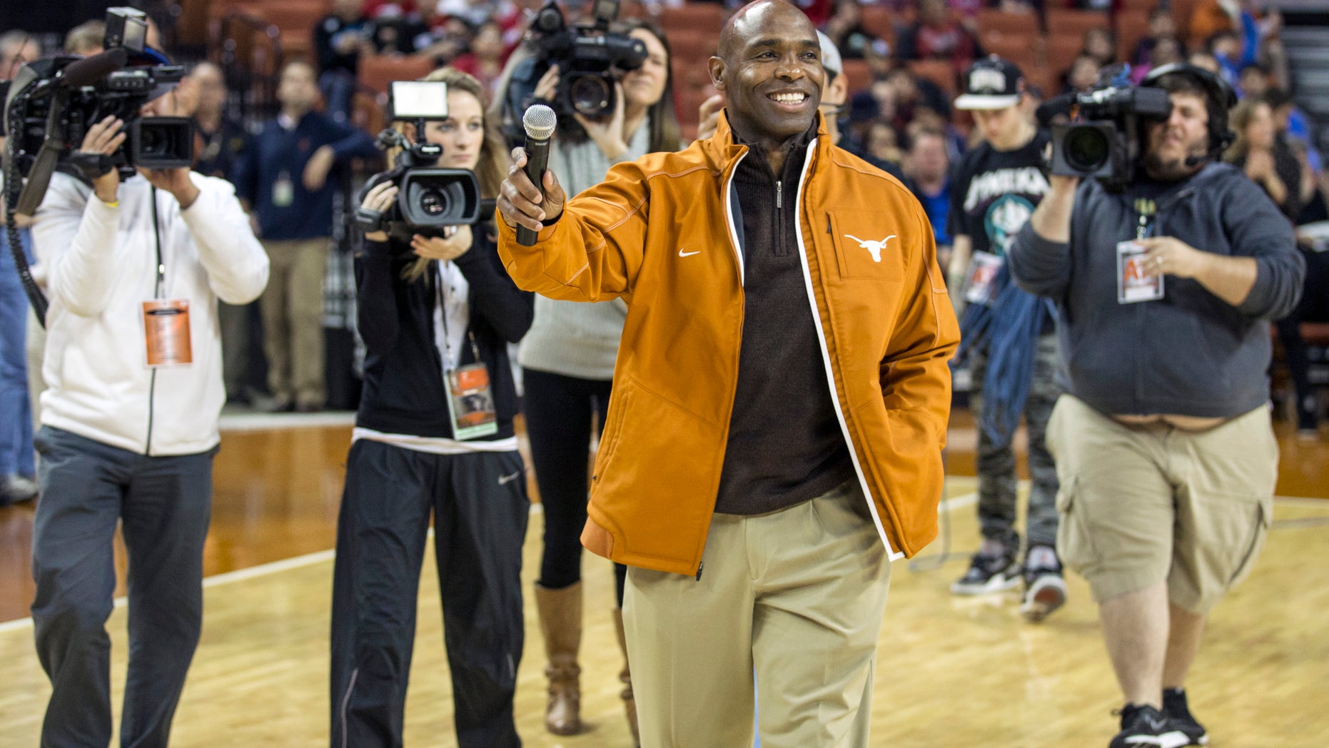 Texas new head football coach Charlie Strong speaks to fans during a timeout against Oklahoma in the first half of an NCAA college basketball game in Austin, Texas, Wednesday, Jan. 8, 2014. (AP Photo/Austin American- Statesman, Ricardo B. Brazziell) AUSTIN CHRONICLE OUT; COMMUNITY IMPACT OUT; INTERNET MUST CREDIT PHOTOGRAPHER AND STATESMAN.COM