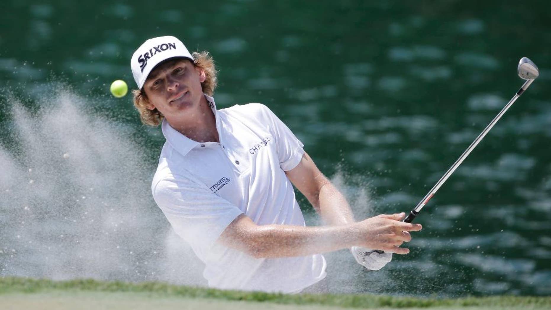 FILE - In this May 12, 2016, file photo, Will Wilcox hits from an 18th hole sand trap during the first round of The Players Championship golf tournament , in Ponte Vedra Beach, Fla. Wilcox is having a memorable debut at The Players Championship. He made a hole-in-one Friday, May 13, 2016, on the island-green 17th, one of the most famous par 3s in golf. (AP Photo/Chris O'Meara, File)