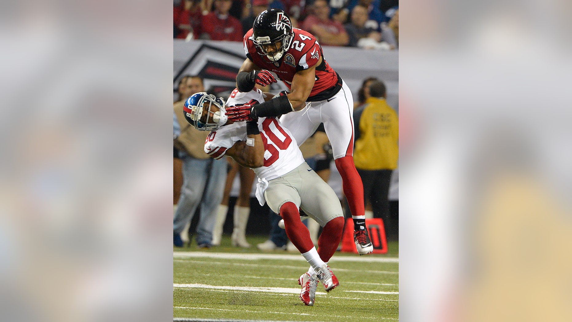 Atlanta Falcons strong safety Chris Hope (24) hits New York Giants wide receiver Victor Cruz (80) during the second half of an NFL football game on Sunday, Dec. 16, 2012, in Atlanta. (AP Photo/Rich Addicks)