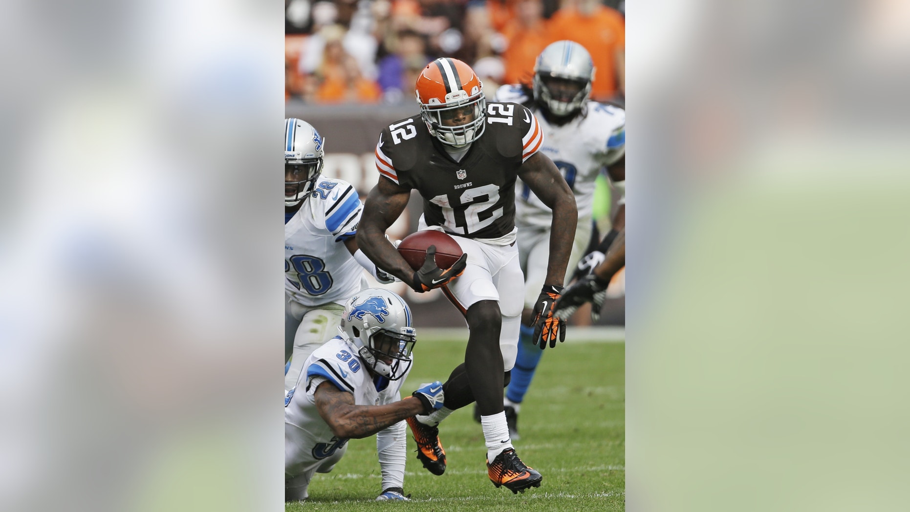 FILE - In this Sunday, Oct. 13, 2013, file photo, Cleveland Browns wide receiver Josh Gordon (12) breaks away from Detroit Lions defensive back Darius Slay (30) after a reception in the fourth quarter of an NFL football game in Cleveland. Gordon is tired of the trade rumors that have been whipping around him for weeks. With Tuesday's deadline approaching, Gordon could be down to his final days in Cleveland, where the front office insists it has not been shopping him to other teams. (AP Photo/Mark Duncan, File)