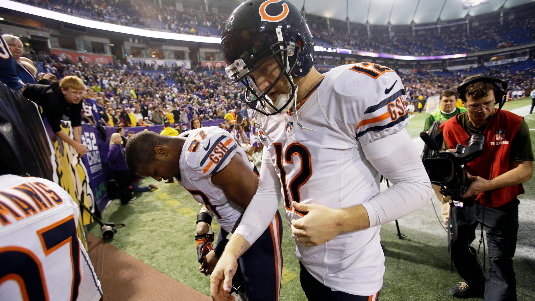 Chicago Bears quarterback Josh McCown (12) walks off the field after an NFL football game against the Minnesota Vikings, Sunday, Dec. 1, 2013, in Minneapolis. The Vikings won 23-20 in overtime. (AP Photo/Jim Mone)