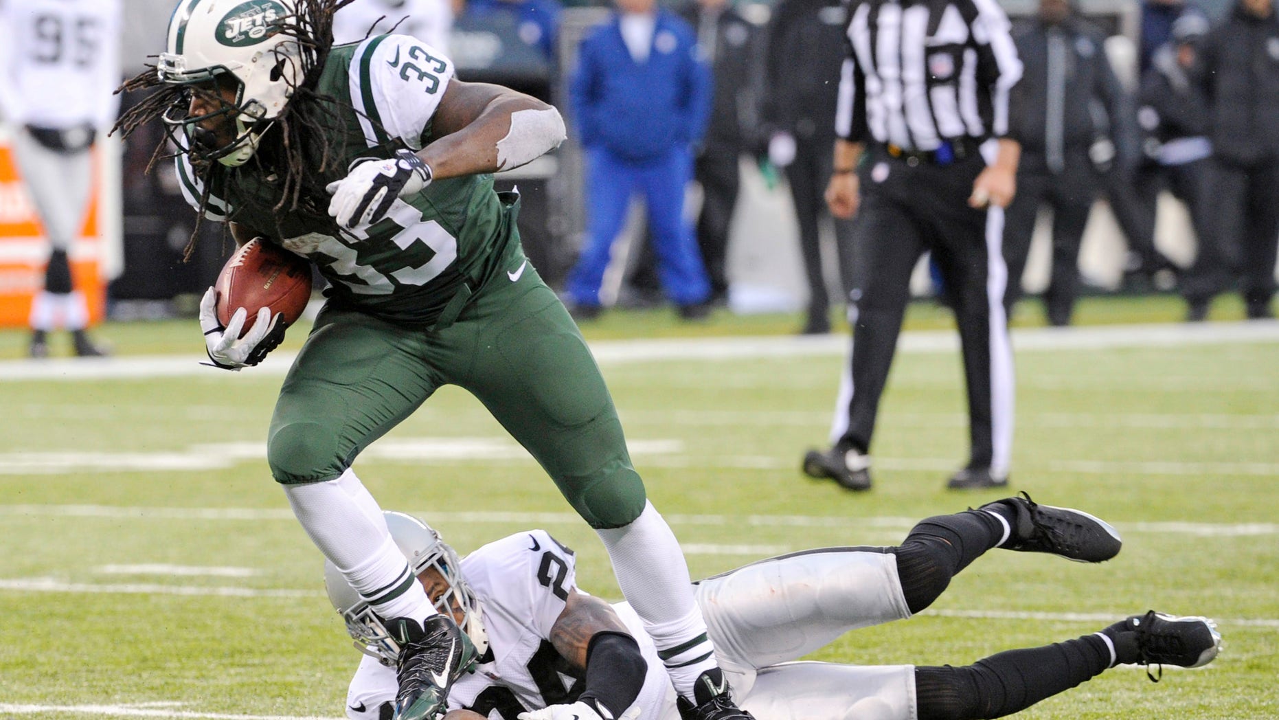 FILE - In this Dec. 8, 2013 file photo, New York Jets running back Chris Ivory (33) breaks away from Oakland Raiders safety Charles Woodson during the second half of an NFL football game, in East Rutherford, N.J. Ivory's carries the ball like a man possessed. (AP Photo/Bill Kostroun), File
