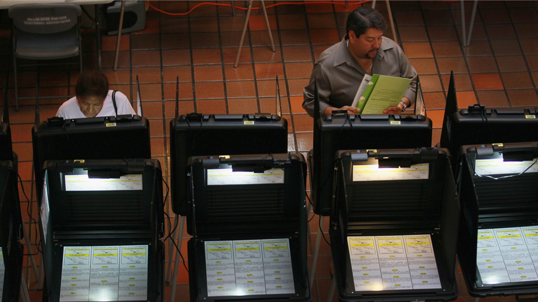 Early voters fill out their ballots as they cast their votes in 2011 in a local Miami election.