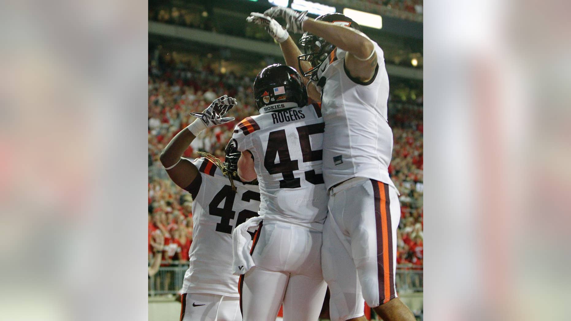 Virginia Tech fullback Sam Rogers (45) celebrates his touchdown against Ohio State with teammates Marshawn Williams, left, and Bucky Hodges during the second quarter of an NCAA college football game Saturday, Sept. 6, 2014, in Columbus, Ohio. (AP Photo/Jay LaPrete)
