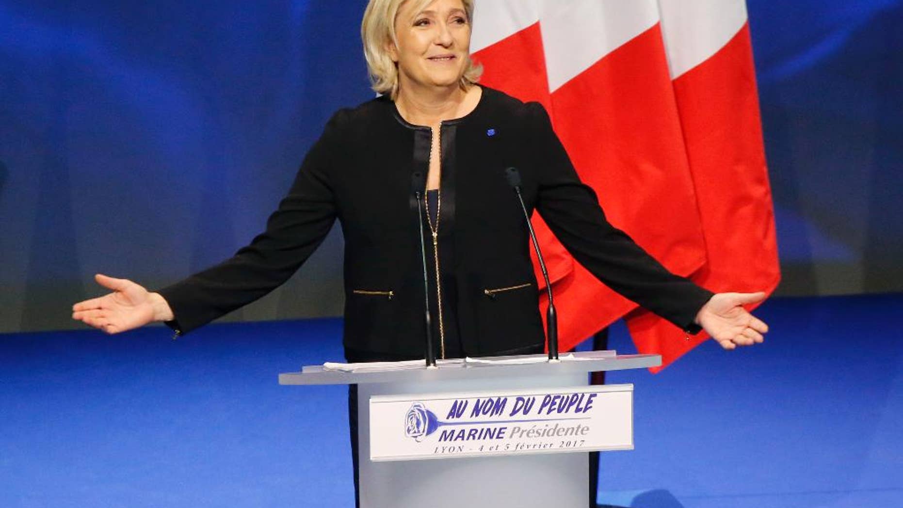 Far-right leader presidential candidate Marine Le Pen gestures as she speaks during a conference in Lyon, France, Sunday, Feb. 5, 2017. Marine Le Pen, the far-right presidential candidate, unveiled her platform Saturday at the start of a weekend conference, envisioning a thriving nation "made in France. (AP Photo/Michel Euler)