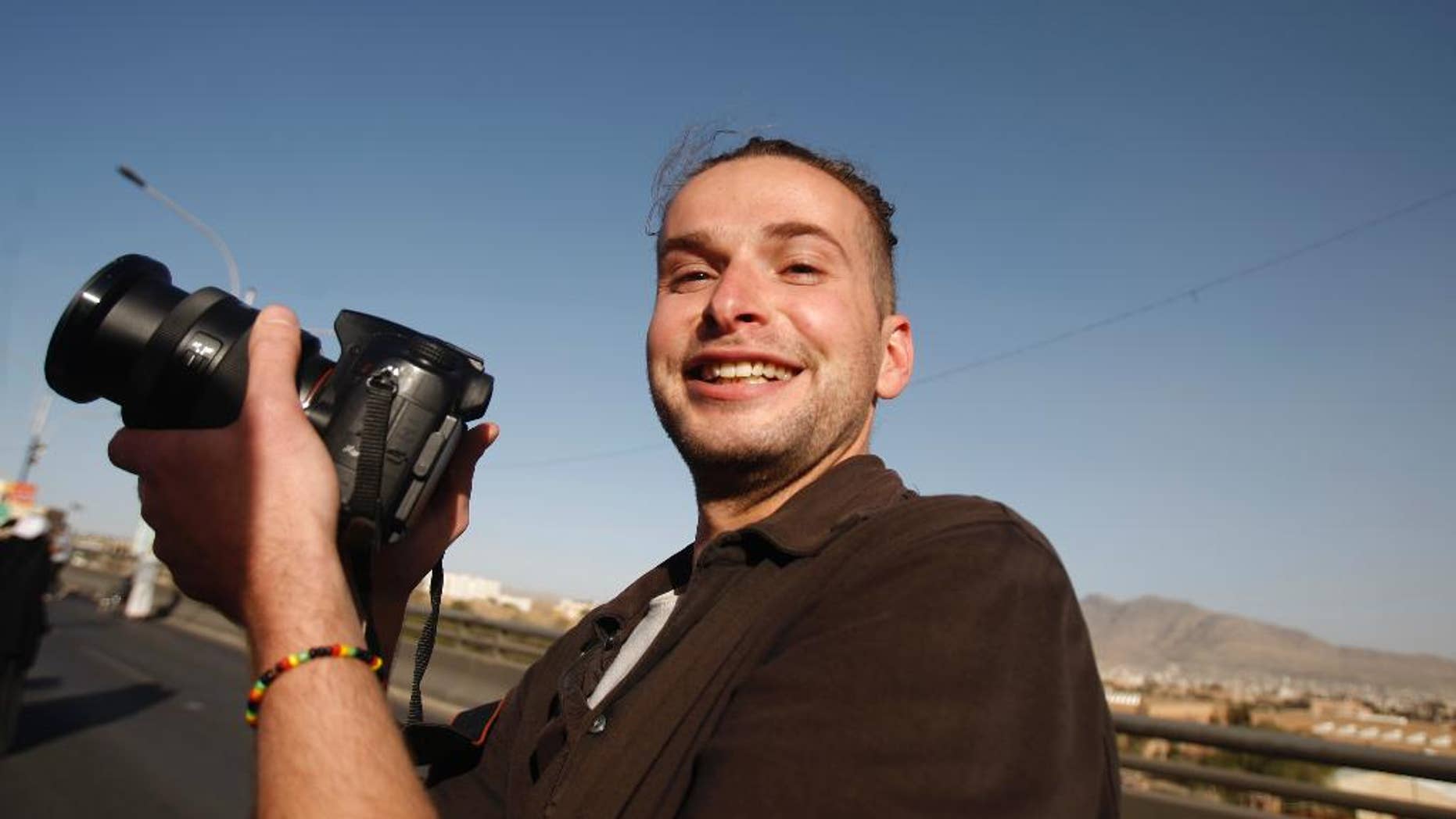 FILE - In this Monday, Feb. 11, 2013 file photo, Luke Somers, 33, an American photojournalist who was kidnapped over a year ago by al-Qaida, poses for a picture during a parade marking the second anniversary of the revolution in Sanaa, Yemen. Somers has been killed in a failed rescue attempt, his sister said Saturday, Dec. 6, 2014. Lucy Somers told The Associated Press that she and her father learned of her 33-year-old brother Luke Somers' death from FBI agents at 0500 GMT (12 a.m. EST) Saturday. (AP Photo/Hani Mohammed, File)