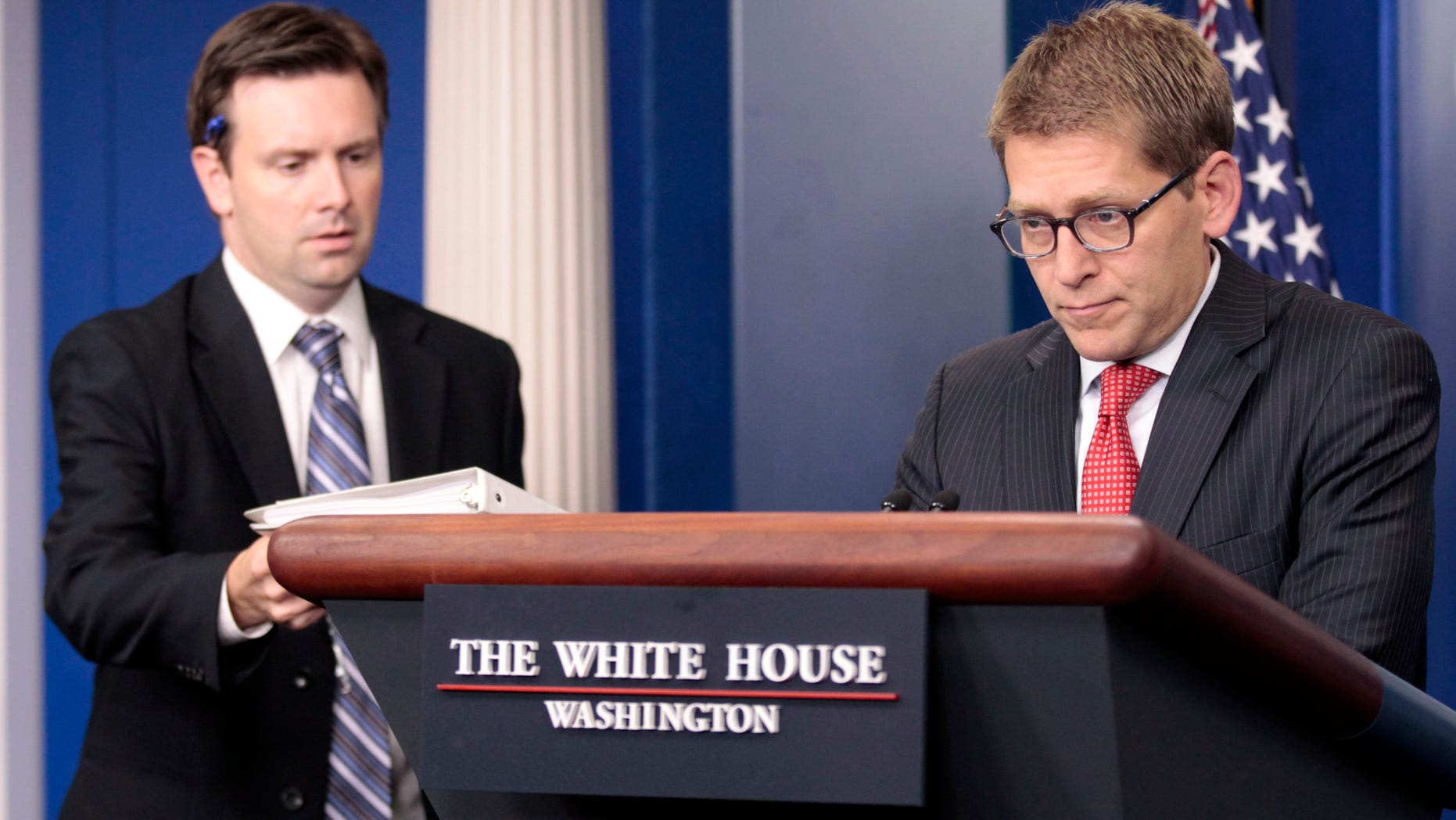 Wednesday: Principal Deputy Press Secretary Josh Earnest, left, hands off the briefing book to White House Press Secretary Jay Carney during the daily news briefing at the White House.