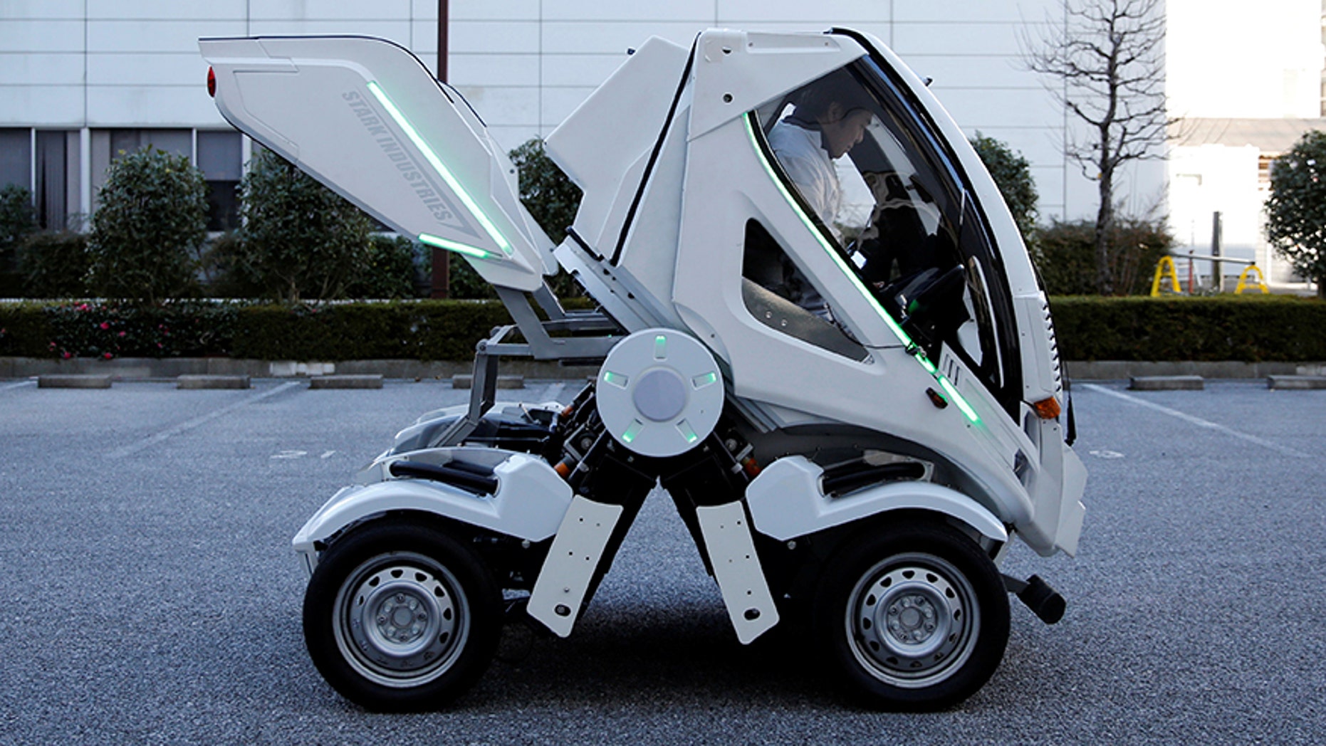 Four Link Systems, Inc's fully electric foldable vehicle 'Earth-1' which was designed by Kunio Okawara, famous in Japan as the artist behind the long-running wildly popular robot anime "Gundam", changes its form in Tokyo, Japan December 27, 2017. Picture taken December 27, 2017. REUTERS/Toru Hanai - RC149EA13170