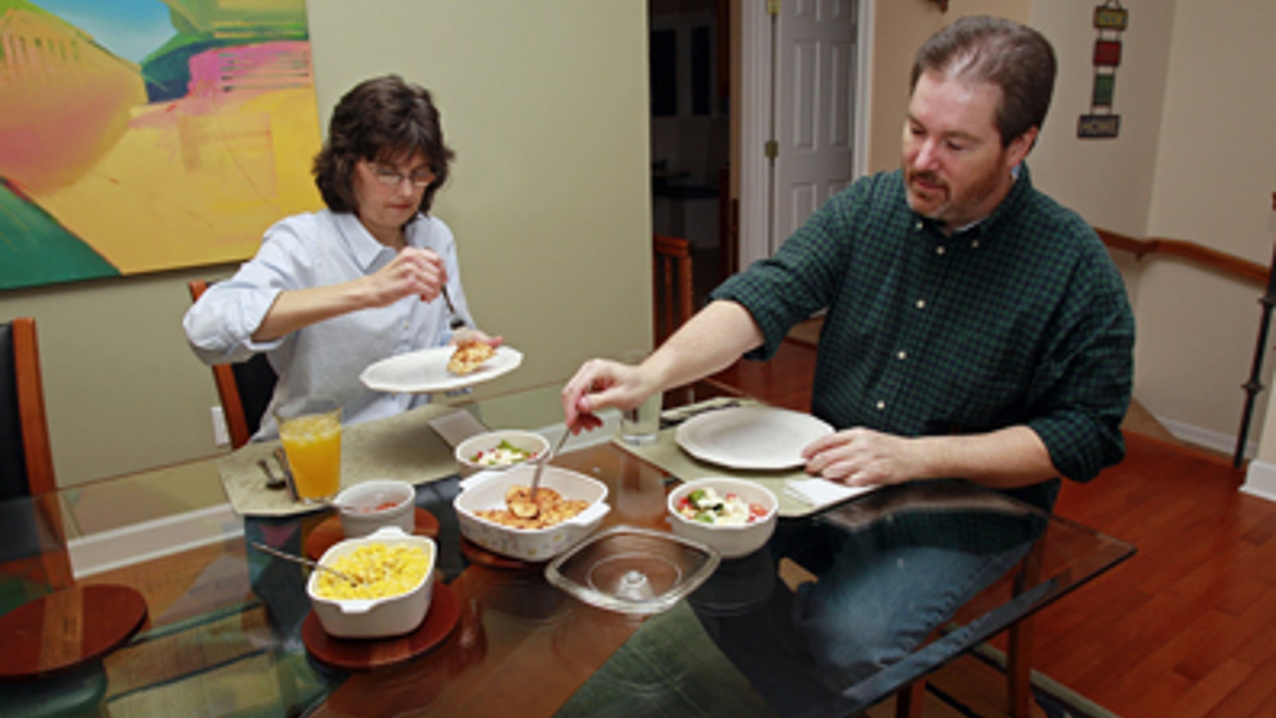 In this Friday, Jan. 14, 2011 photo, Beverly and Eugene Murray have dinner at their home in Cary, N.C. As the economy improves and families have more spending money, they're still saving restaurants for special occasions. (AP Photo/Gerry Broome)